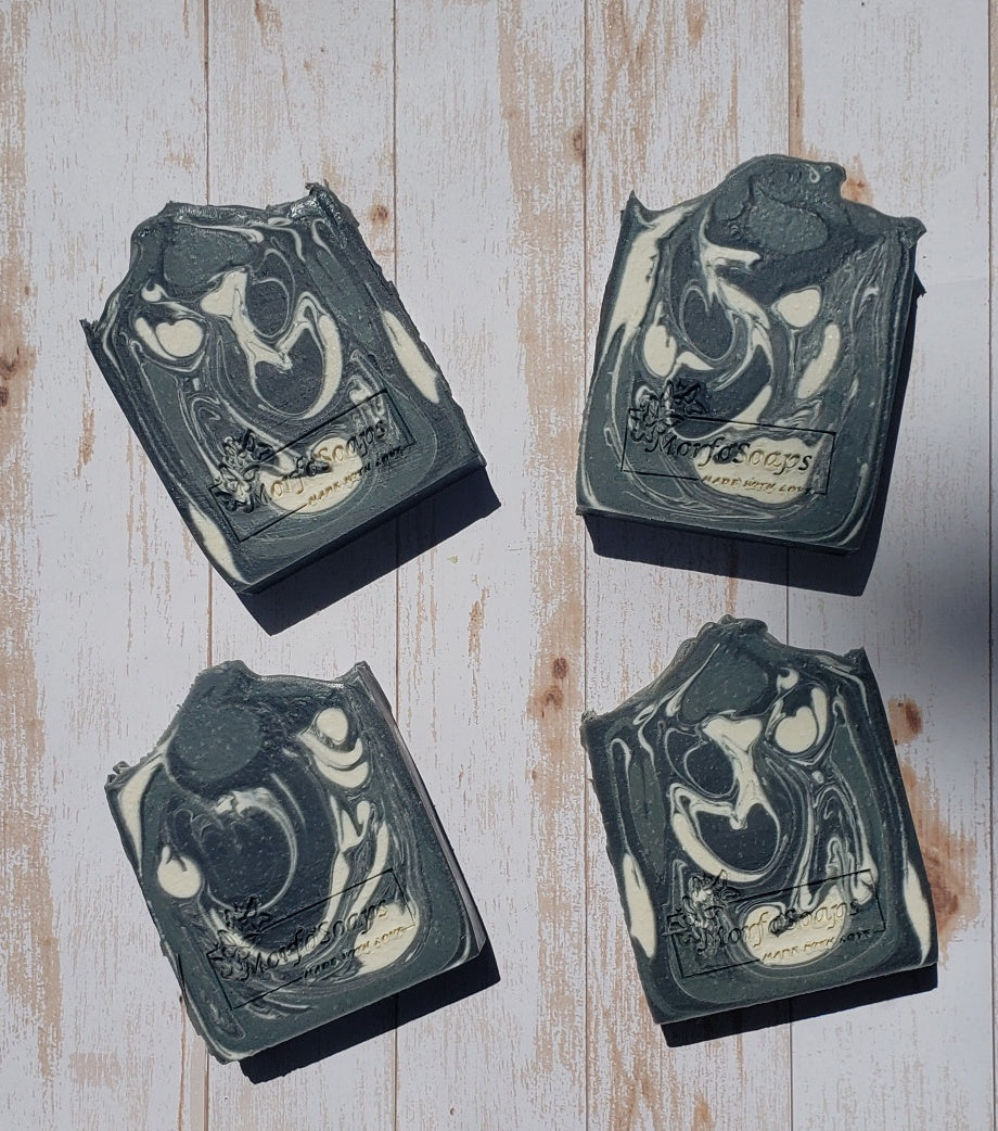 A bar of MorfoSoaps' All Natural Eucalyptus Soap, showcasing its unique color and texture, made with eucalyptus oil and activated charcoal.