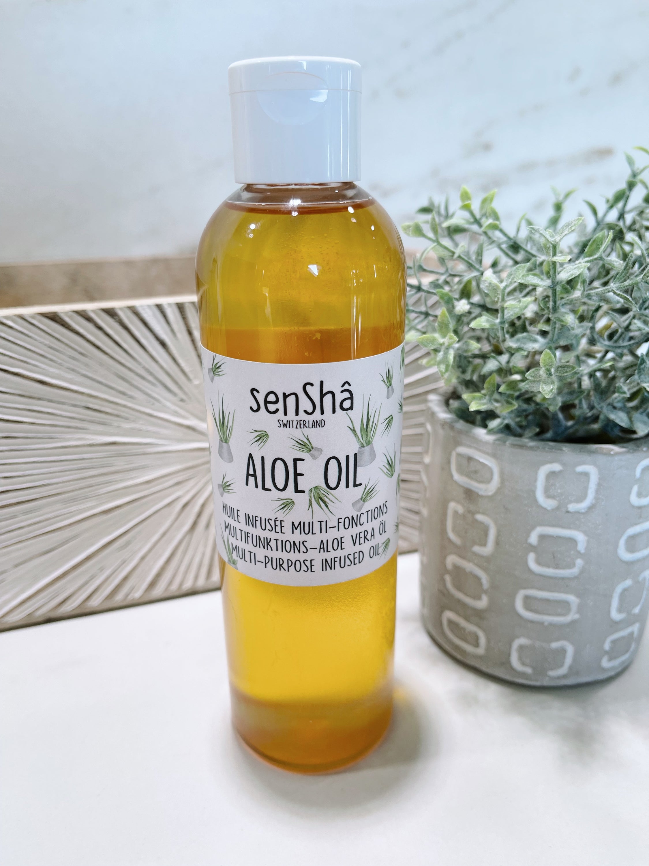 250ml bottle of Aloe Vera Oil for face, body, and hair care, featuring a sleek design and natural ingredients.