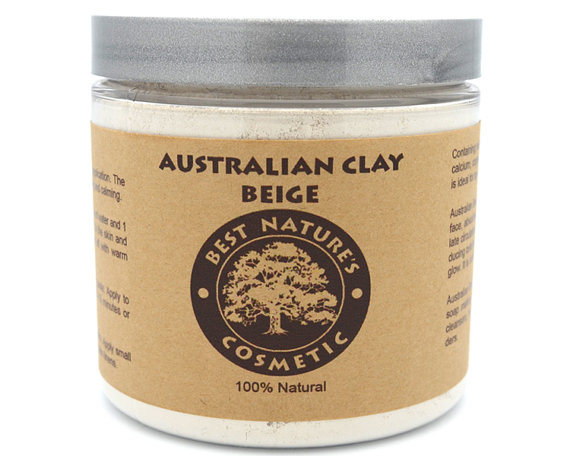 A bowl of Australian Beige Clay powder with a wooden spoon, showcasing its fine texture and natural color, ideal for skincare treatments.