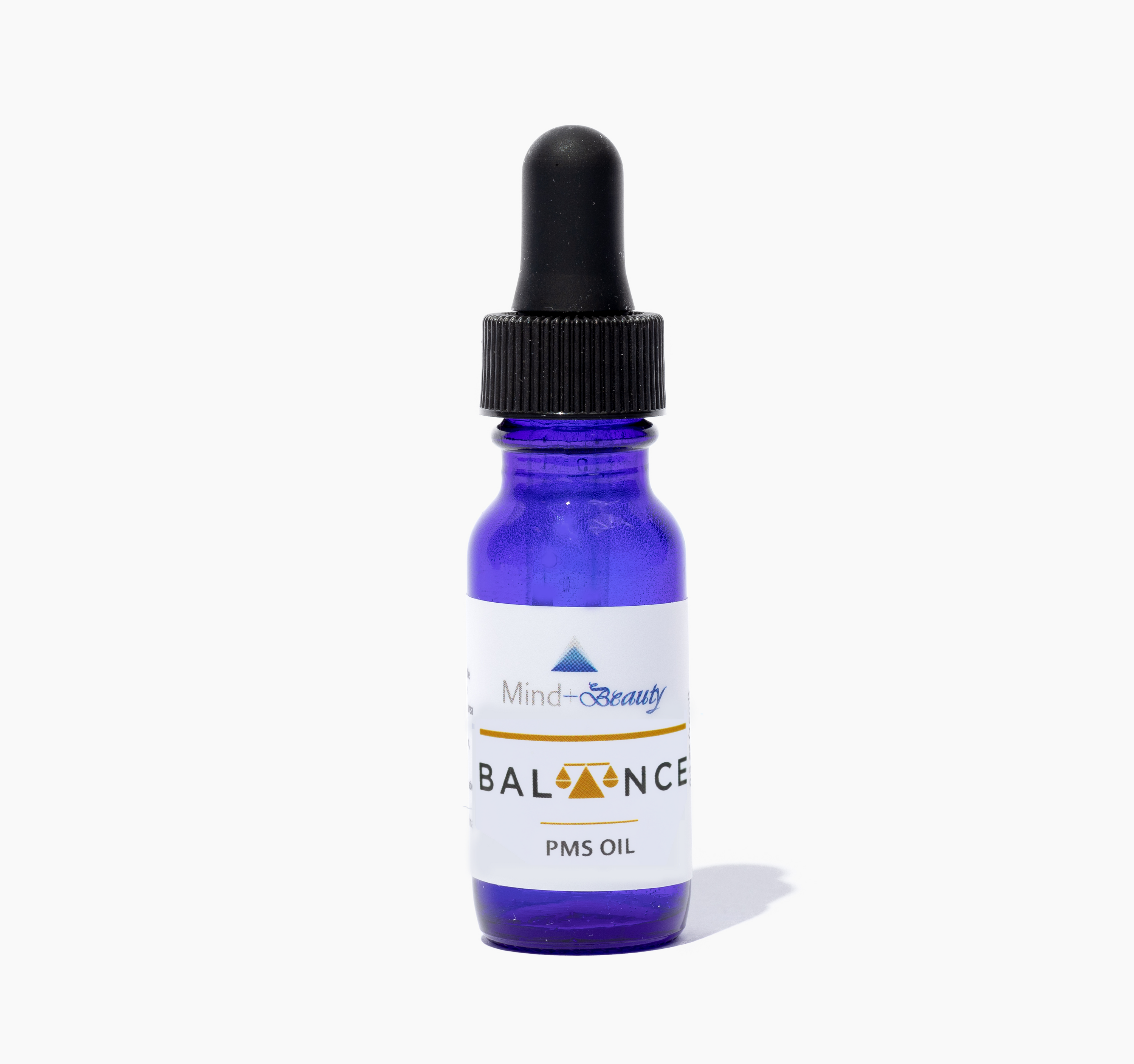 A bottle of Balance Oil (PMS) with a dropper, surrounded by natural ingredients like almonds and essential oils.