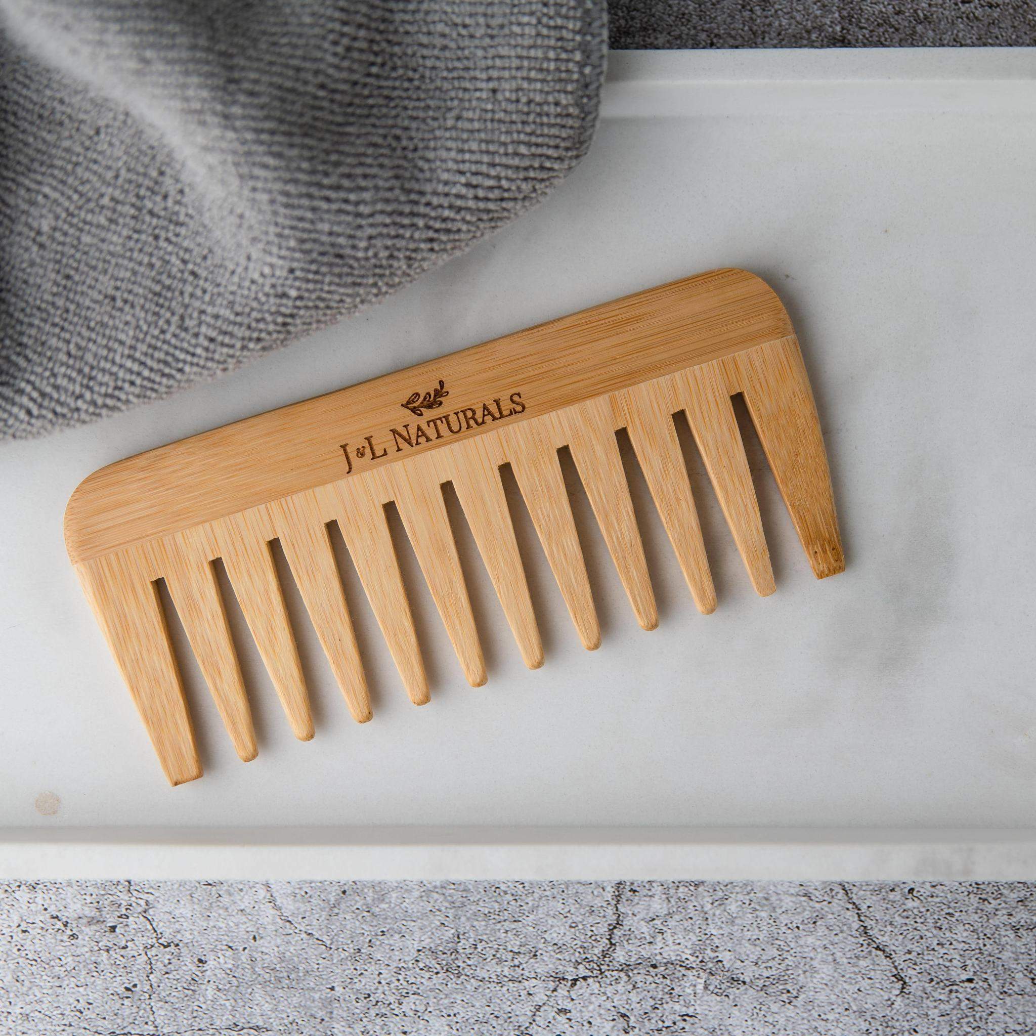 A wide-tooth bamboo detangling comb, perfect for reducing hair breakage and detangling thick or curly hair.