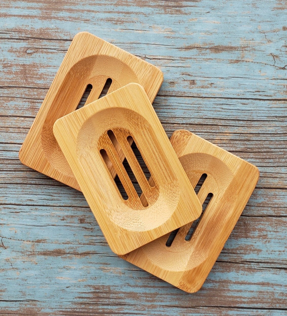 Eco-friendly Bamboo Soap Dish by Morfosoaps with a sloped surface for drainage and a non-slip bottom, showcasing its natural bamboo finish.