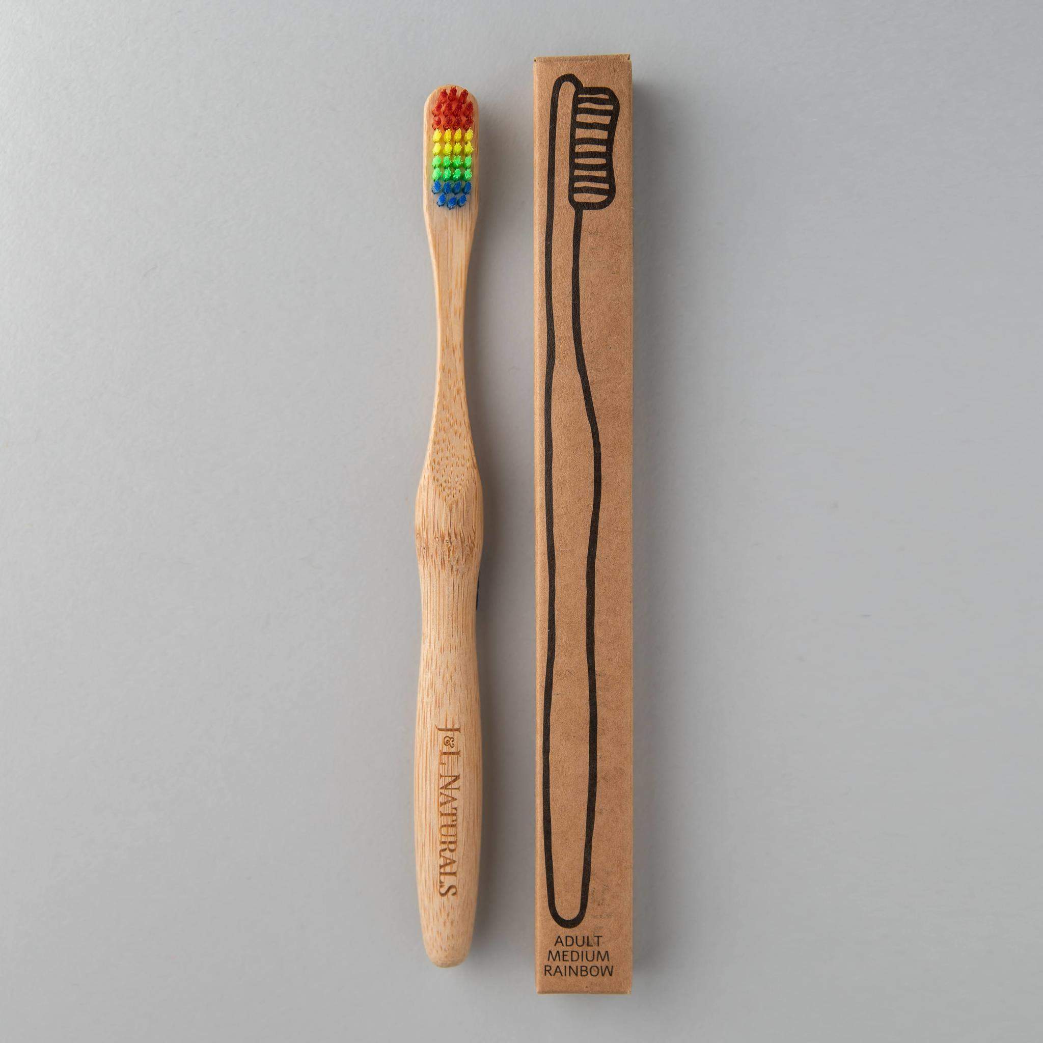 A bamboo toothbrush with medium wavy bristles and an ergonomic handle, available in various colors including black, white, natural, and rainbow.