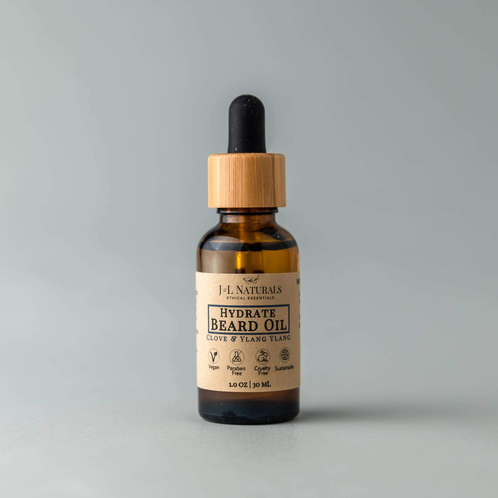 A bottle of Beard Oil with a dropper, showcasing its rich, golden liquid, set against a rustic wooden background.