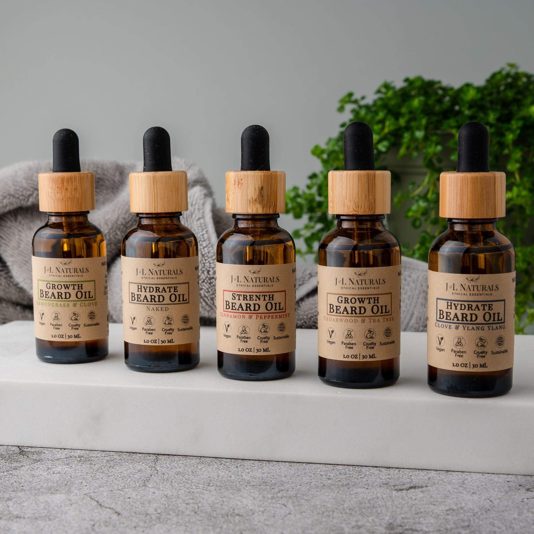 Beard Oil Bundle featuring five bottles of premium grooming oils in various scents, designed for beard care and growth.