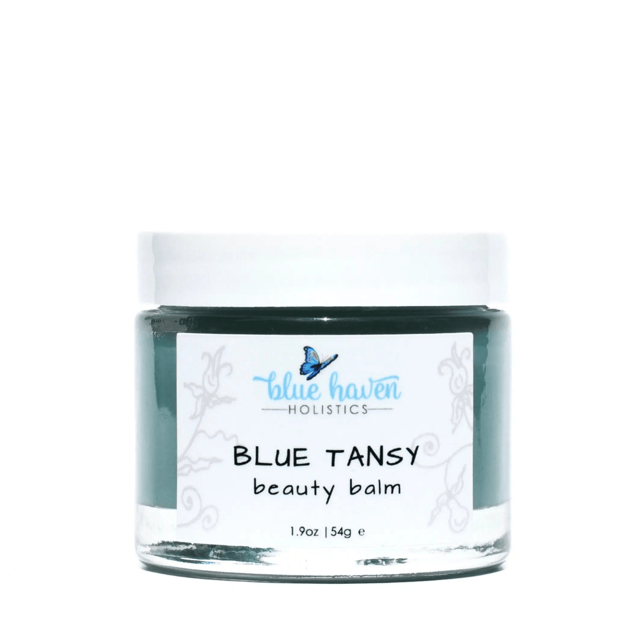 Blue Tansy Beauty Balm in a jar, showcasing its rich, creamy texture and vibrant blue color, surrounded by natural ingredients.