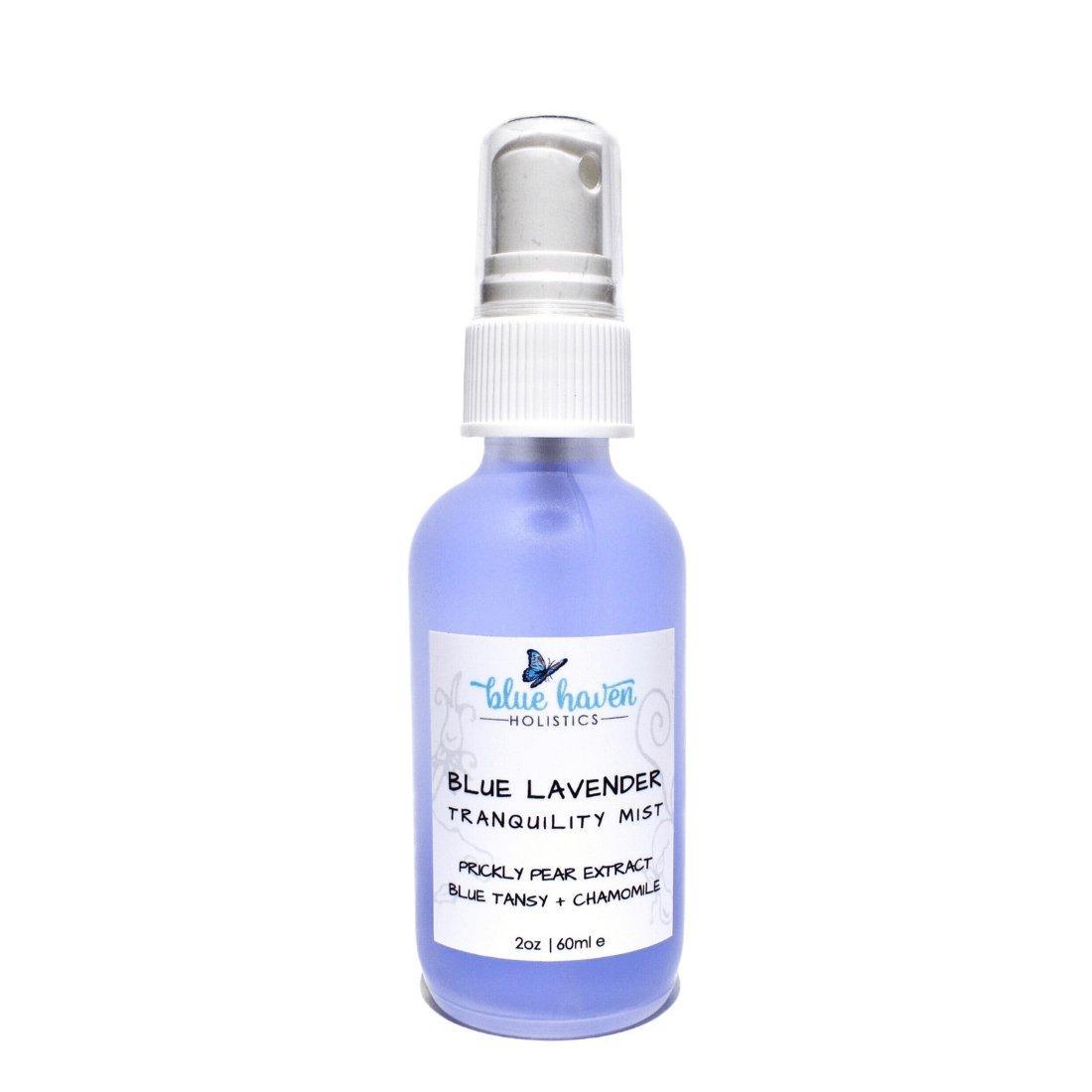 Blue Tansy Hydrating Face Mist bottle with a calming blue hue, surrounded by lavender and chamomile flowers, showcasing its natural ingredients.