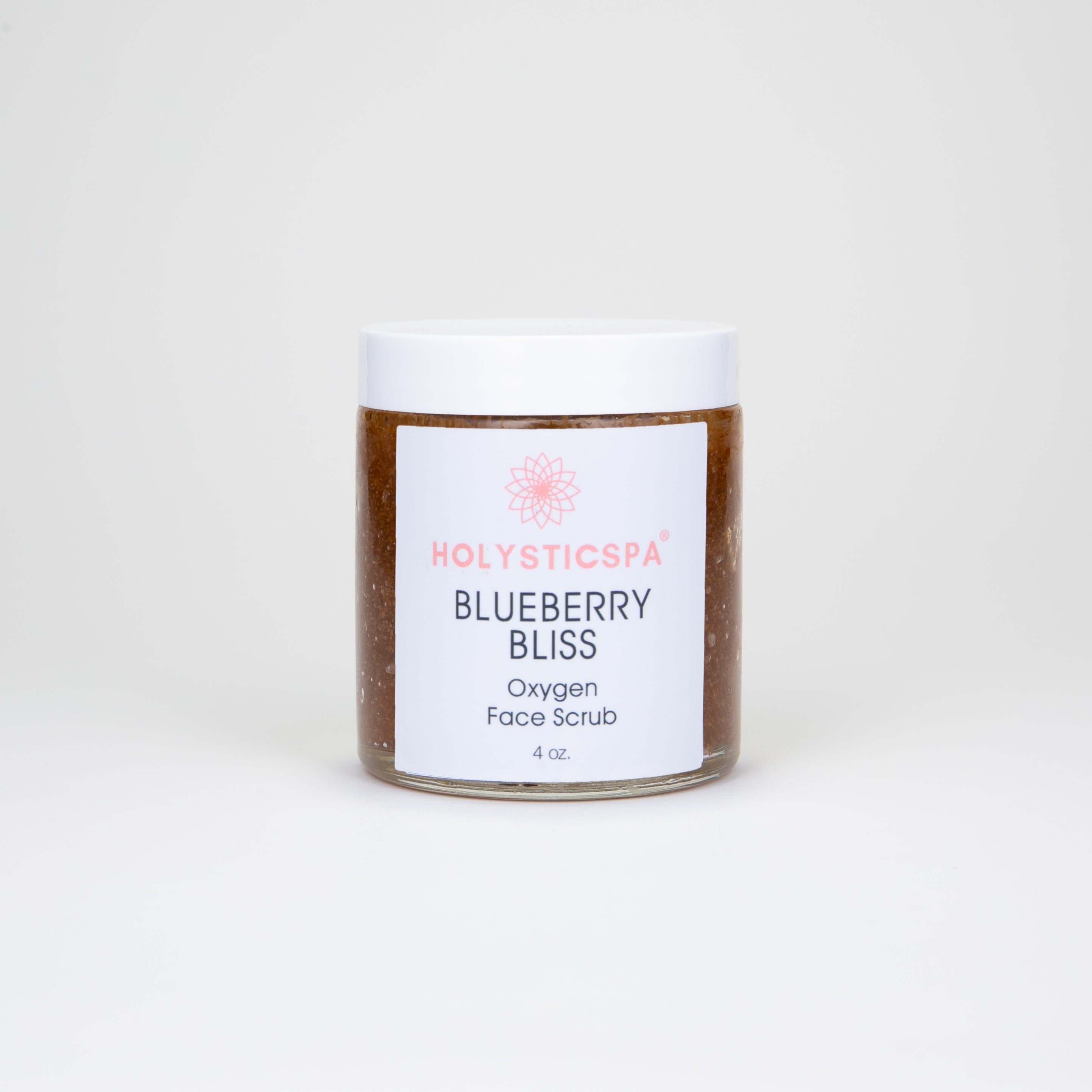 Blueberry Bliss Face Scrub in a jar with blueberries and cranberries around it, showcasing its natural ingredients.