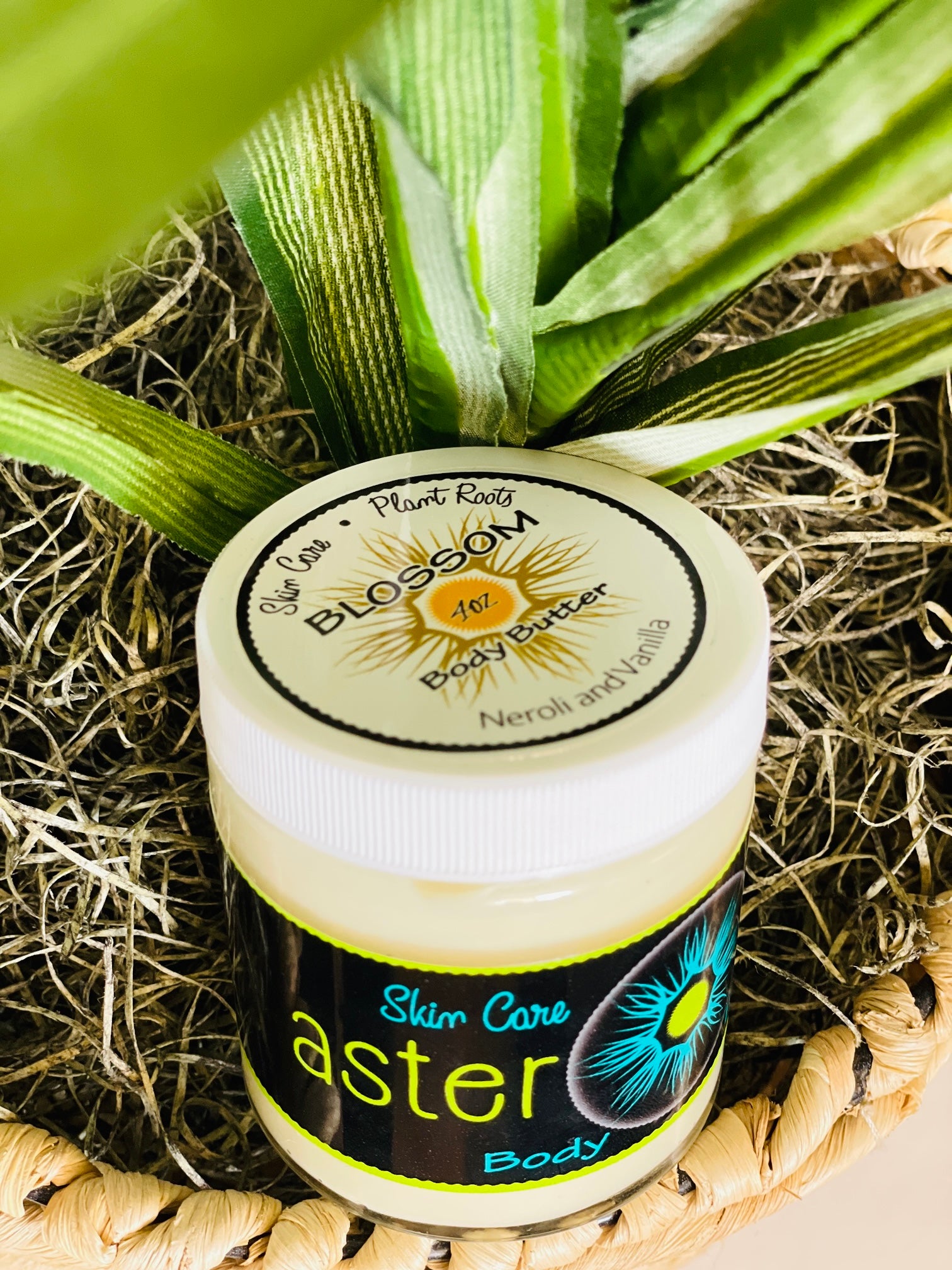 A jar of BLOSSOM Body Butter featuring a creamy texture, with a floral design on the label, showcasing its natural ingredients.