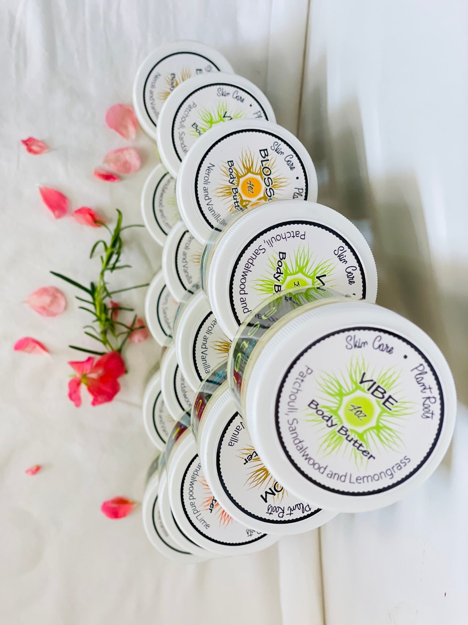 A jar of BLOSSOM Body Butter featuring a creamy texture, with a floral design on the label, showcasing its natural ingredients.