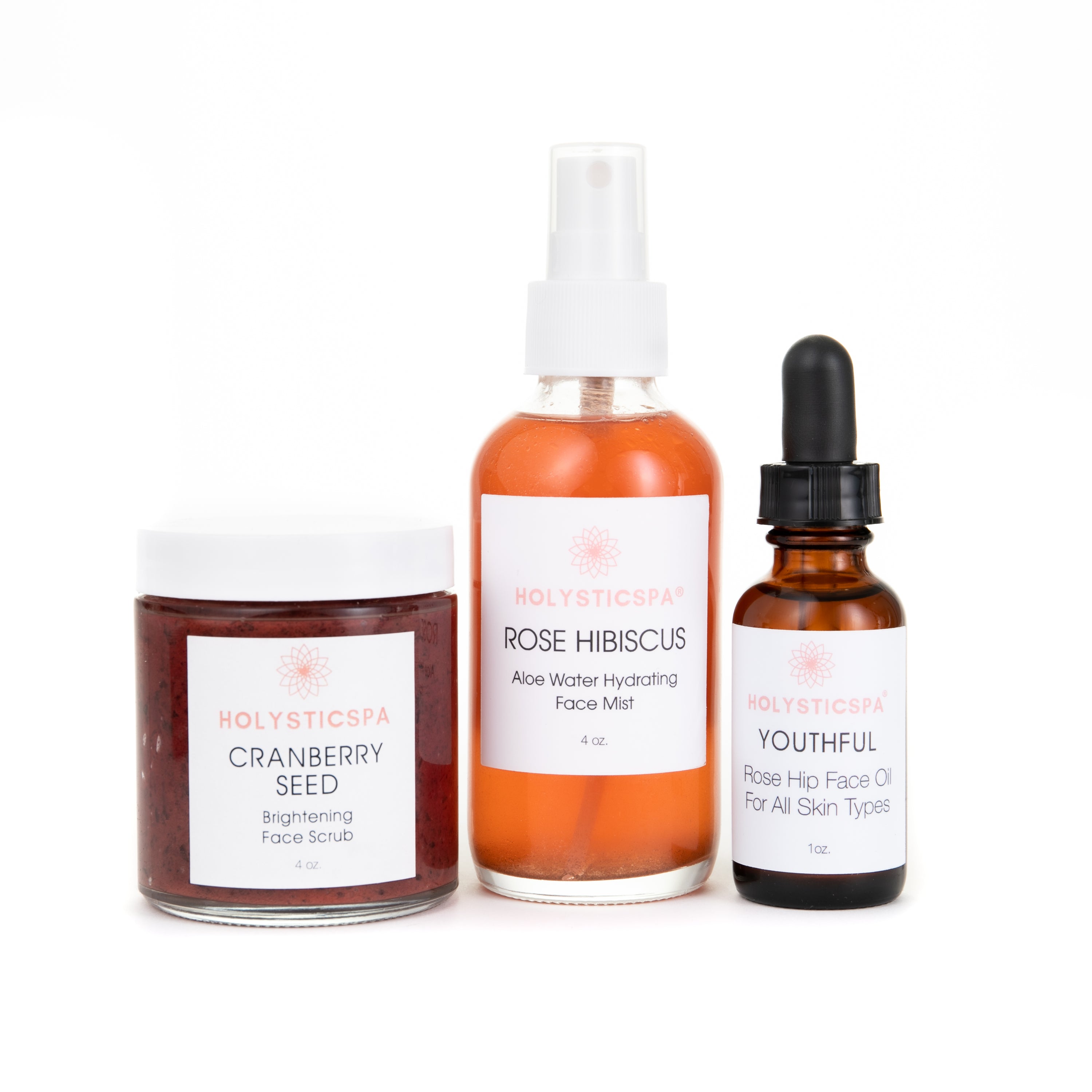 Brightening Skincare Bundle featuring Cranberry Seed Face Scrub, Youthful Face Oil, and Rose Hibiscus Face Mist in elegant packaging.