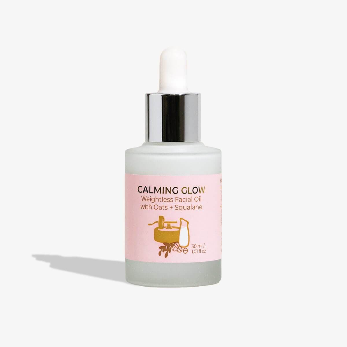 Calming Glow Weightless Facial Oil bottle with Oats and Squalane, showcasing its elegant design and nourishing properties.