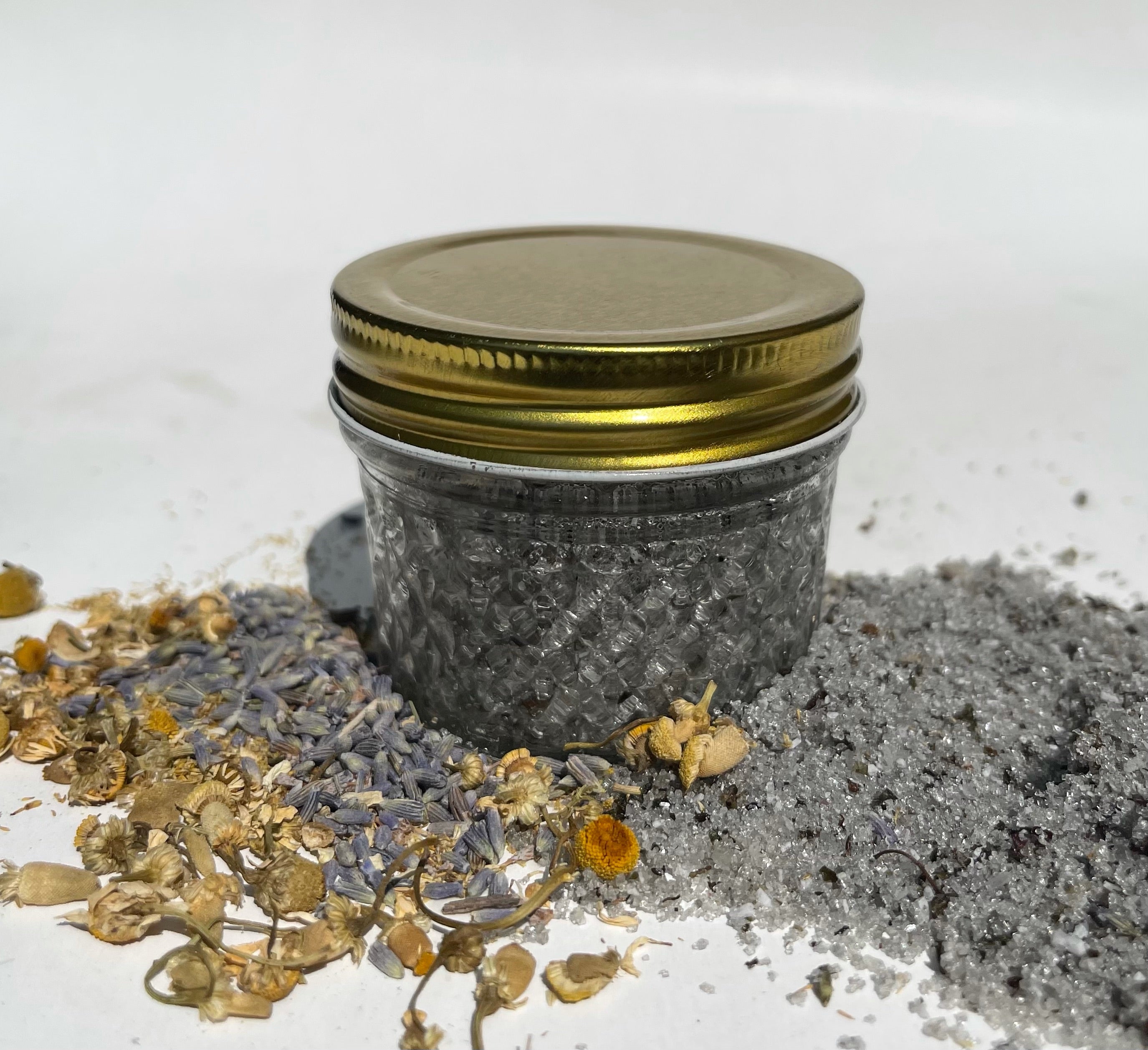 Chill Exfoliating Scrub in a reusable glass jar with natural ingredients like cane sugar, Himalayan black salt, and coconut oil.