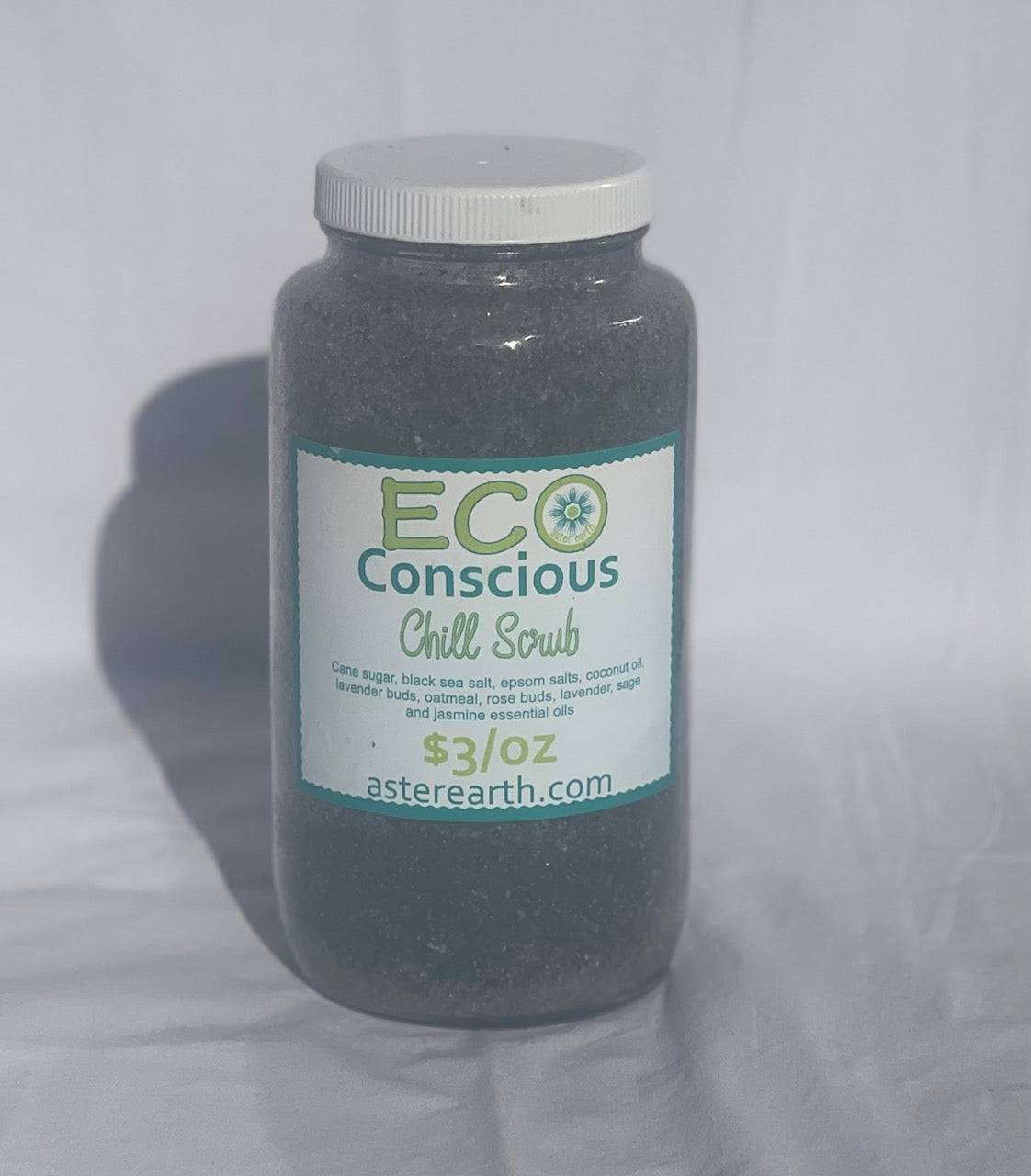 Chill Exfoliating Scrub in a reusable glass jar with natural ingredients like cane sugar, Himalayan black salt, and coconut oil.