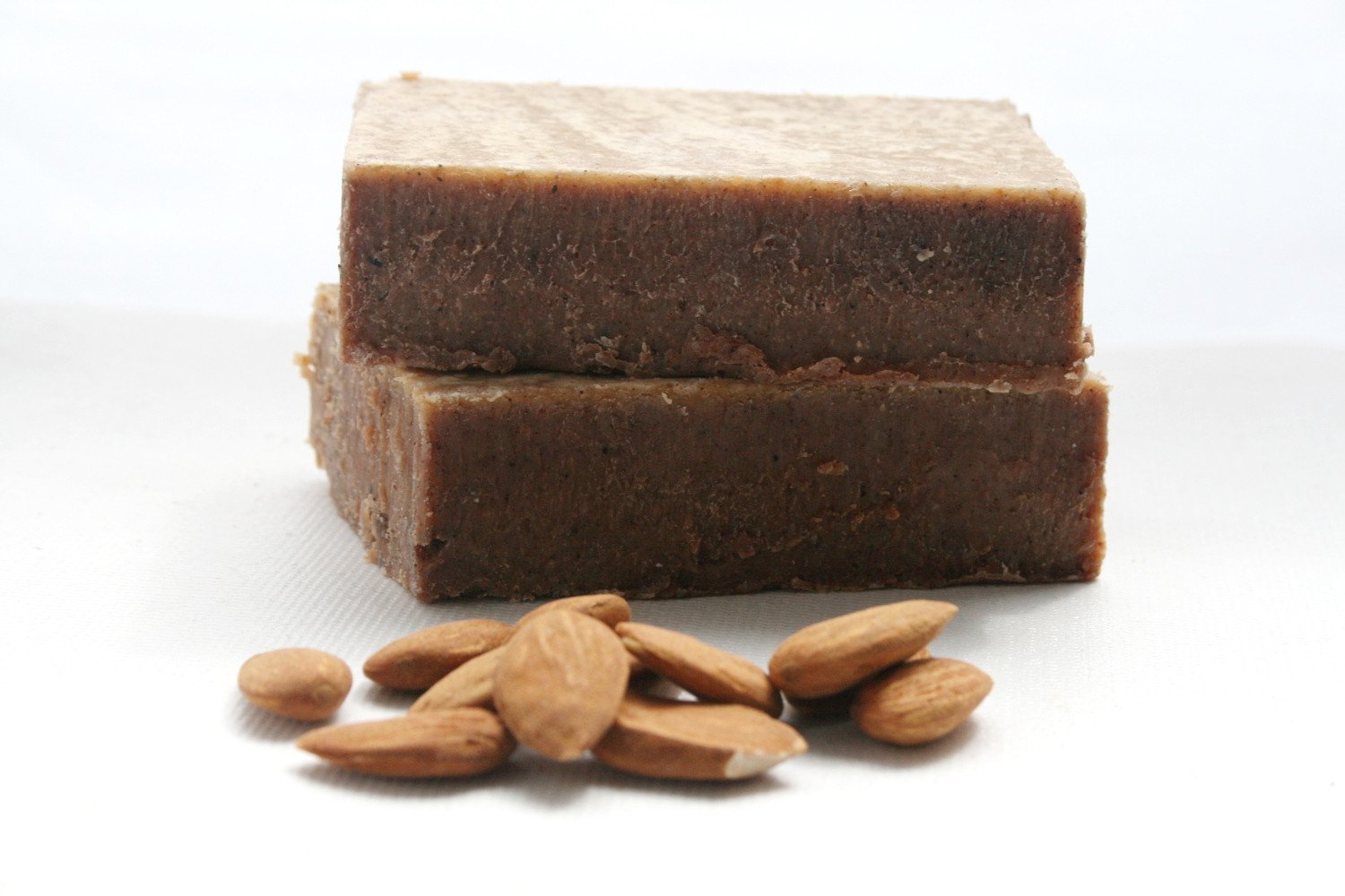 Cinnamon Honey and Almond Soap bar with crushed almonds, showcasing its natural texture and color.