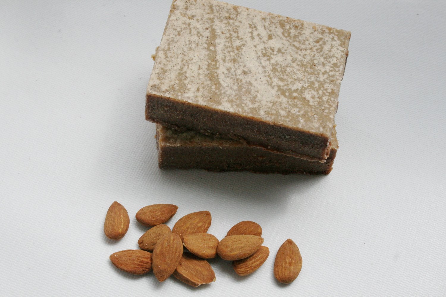 Cinnamon Honey and Almond Soap bar with crushed almonds, showcasing its natural texture and color.