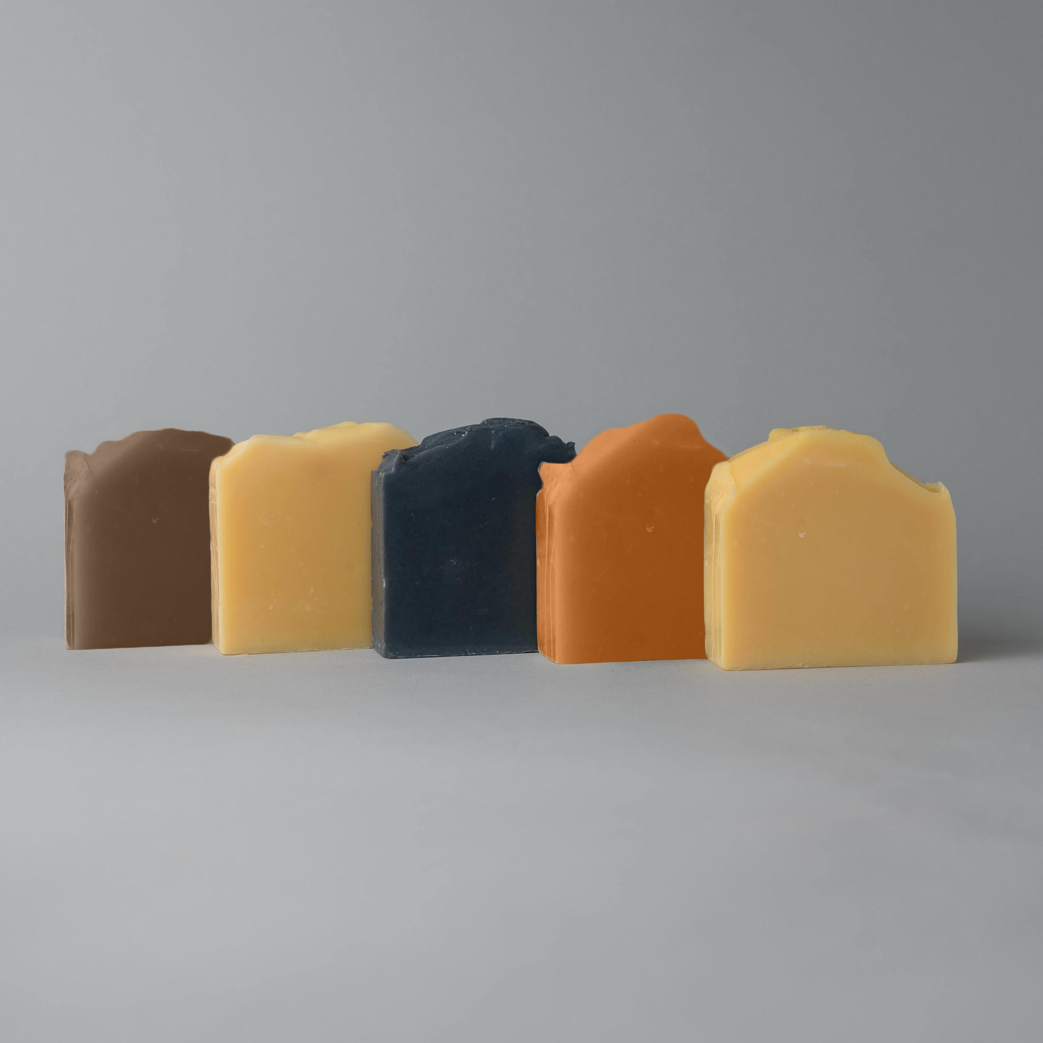 A natural Cleansing Bar displayed on a wooden surface, showcasing its smooth texture and eco-friendly packaging.