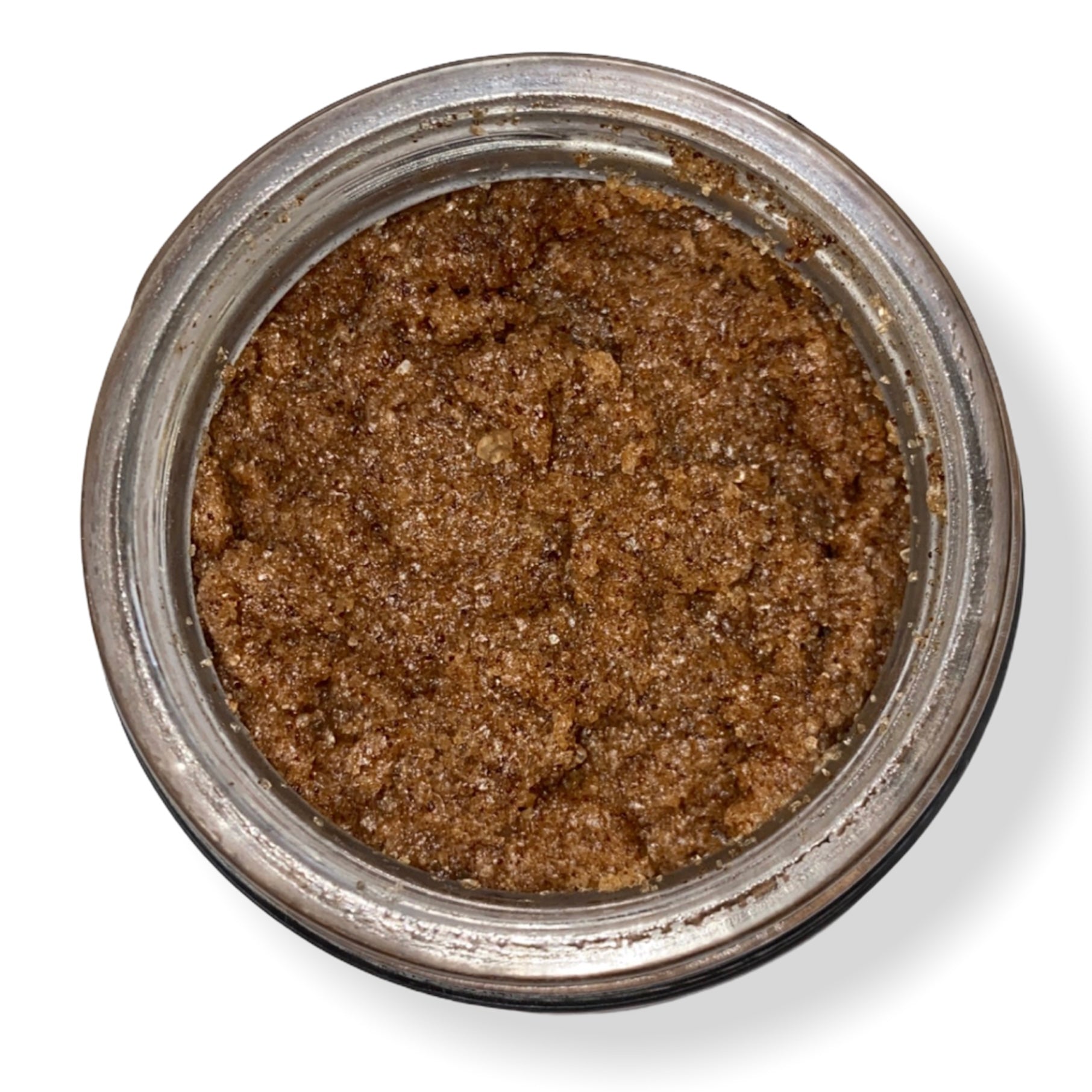 Coffee Salt Body Scrub in a clear jar, showcasing the coarse texture and rich ingredients, perfect for exfoliating and nourishing skin.