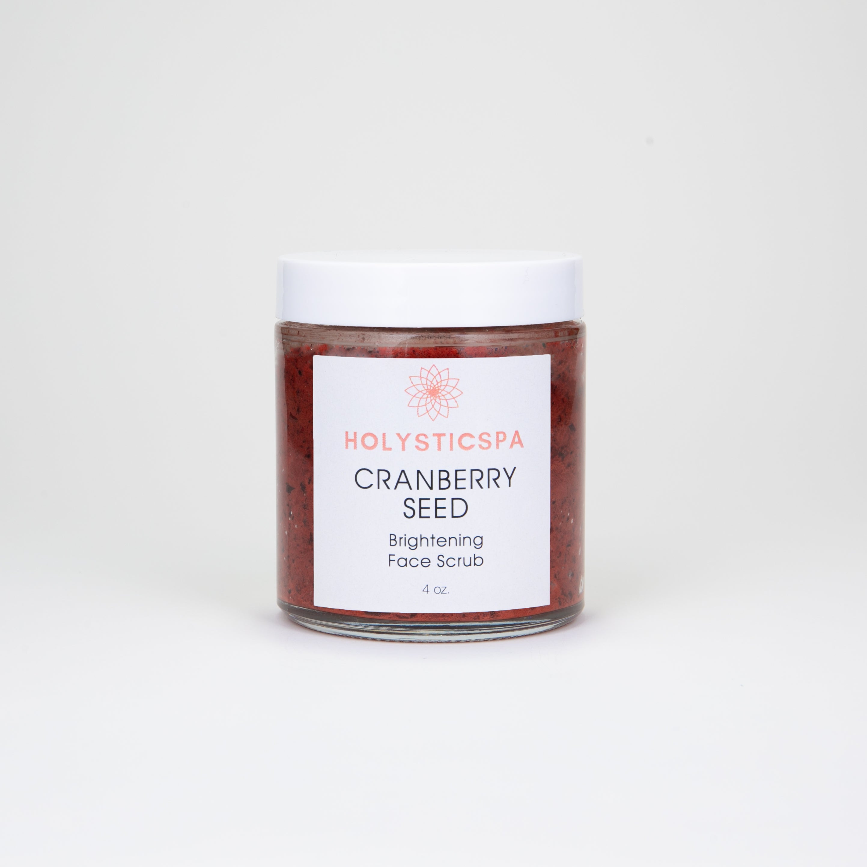 Cranberry Seed Brightening Face Scrub in a jar with cranberries and natural ingredients around it, showcasing its exfoliating properties.