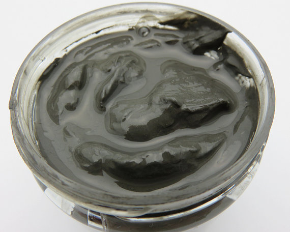 A jar of Dead Sea Mineral Mud showcasing its rich, dark texture, ideal for detoxifying and rejuvenating skin.