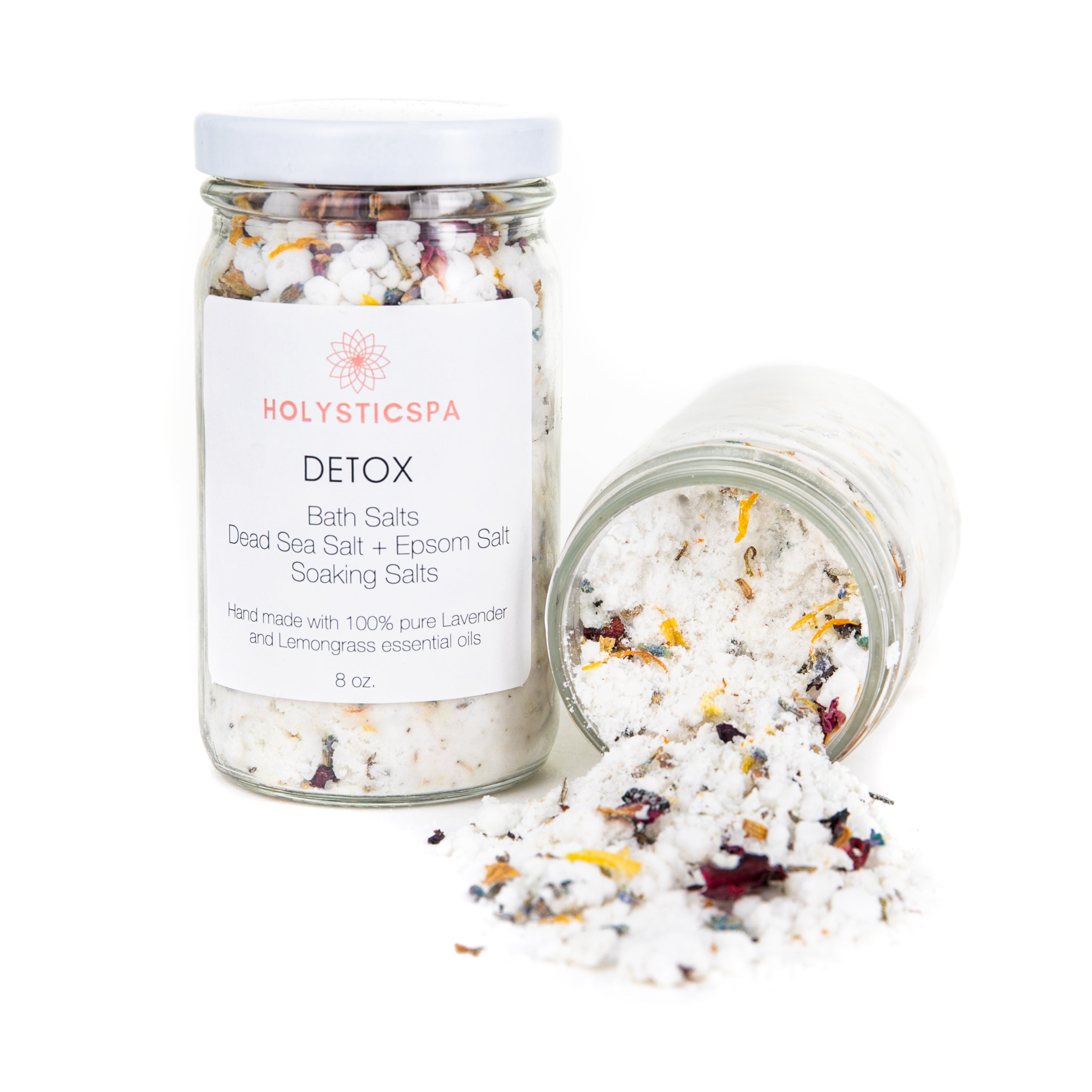 A jar of Detox Bath Salt with lemongrass and lavender, surrounded by dried lavender flowers and rose buds.