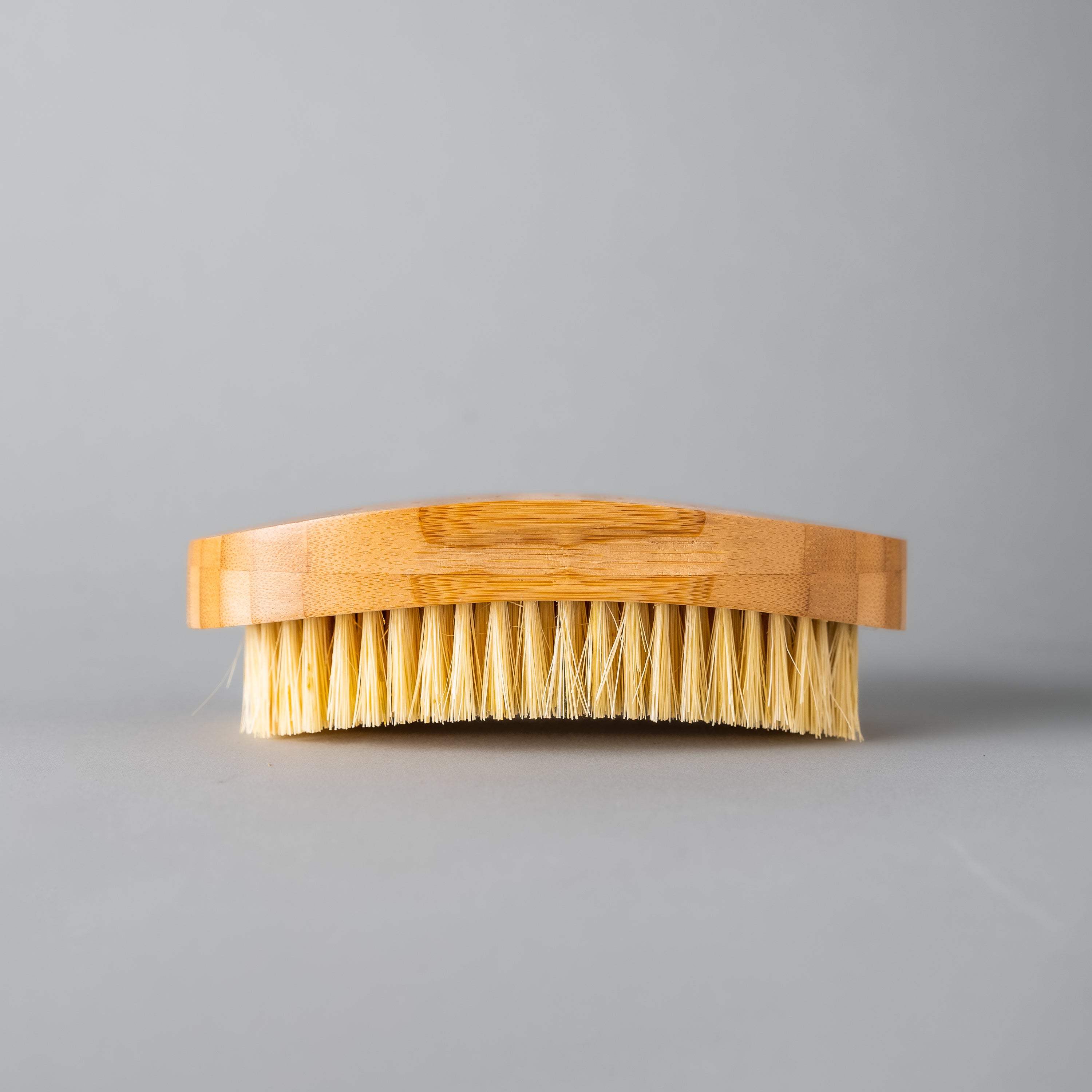 A natural Dry Brush made from bamboo and sisal fibers, designed for exfoliating and rejuvenating skin.