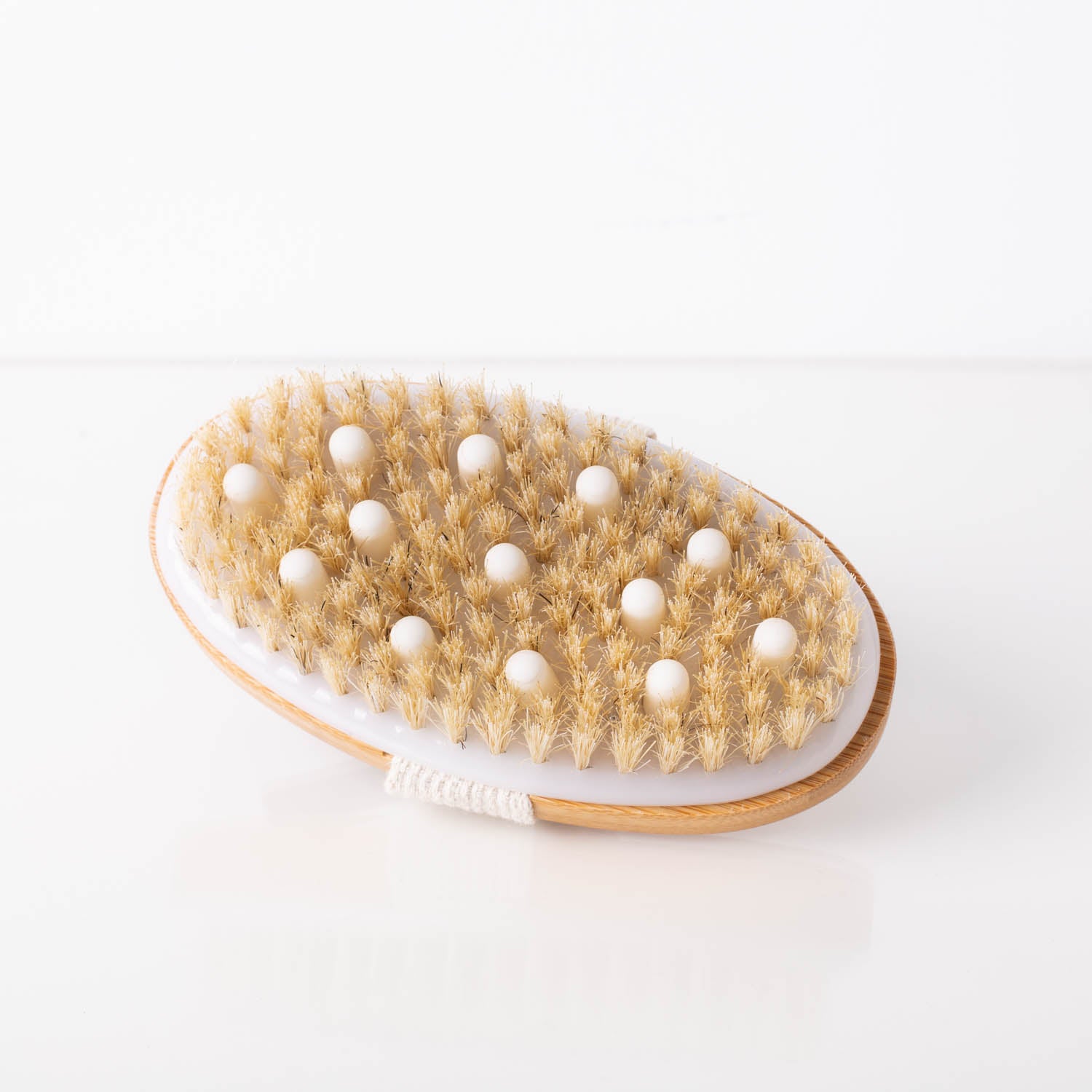 A natural bristle dry brushing body brush with an ergonomic handle, ideal for exfoliating skin and promoting lymphatic drainage.