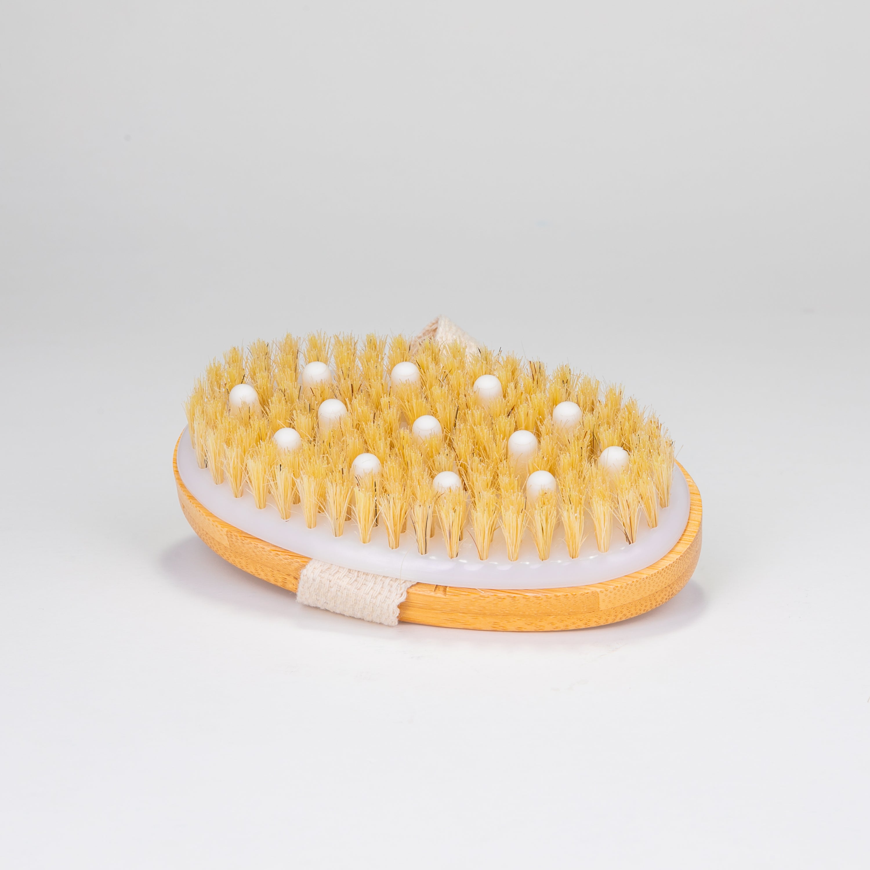 A natural bristle dry brushing body brush with an ergonomic handle, ideal for exfoliating skin and promoting lymphatic drainage.