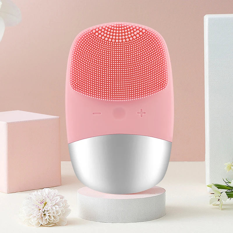 Electric Face Cleansing Brush in pink color, showcasing its ergonomic design and compact size.