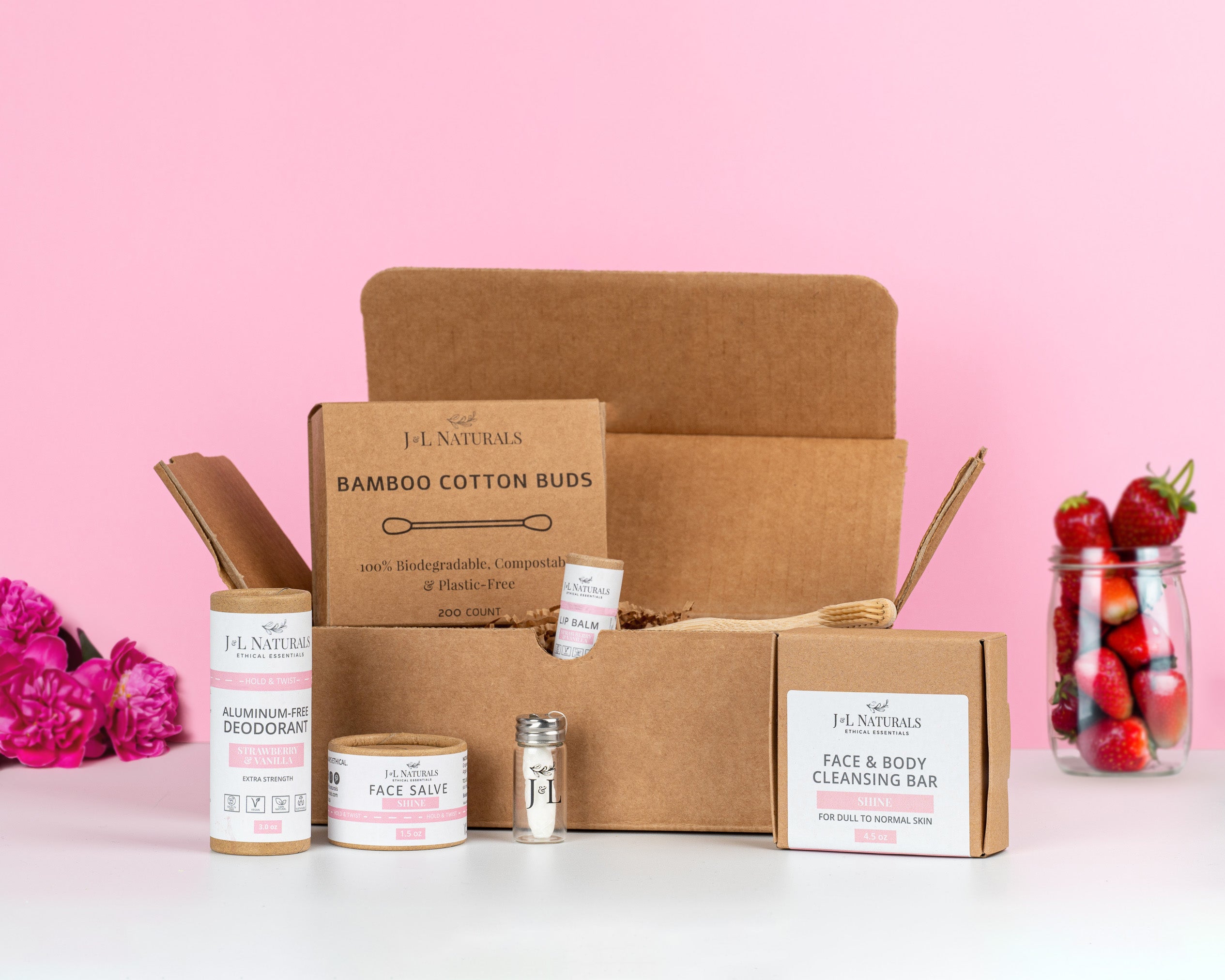 Essentials Self Care Kit featuring 7 skincare products including cleansing bar, face salve, lip balm, deodorant, bamboo toothbrush, floss, and cotton buds.