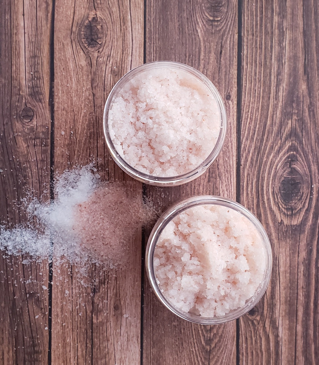 A jar of Eucalyptus Bath Salt with eucalyptus leaves and a wooden scoop, showcasing its natural ingredients and soothing properties.