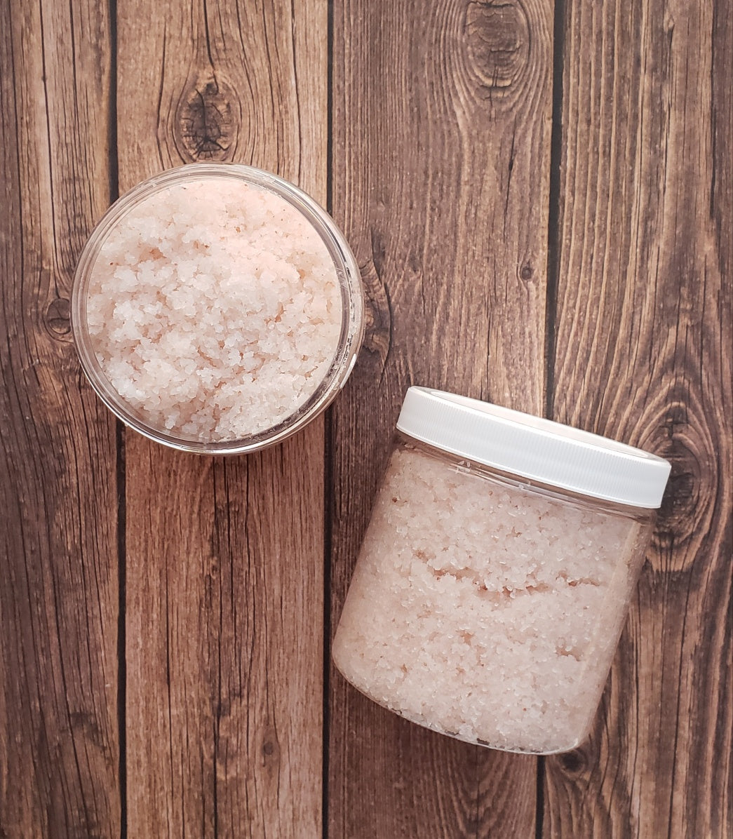 A jar of Eucalyptus Bath Salt with eucalyptus leaves and a wooden scoop, showcasing its natural ingredients and soothing properties.