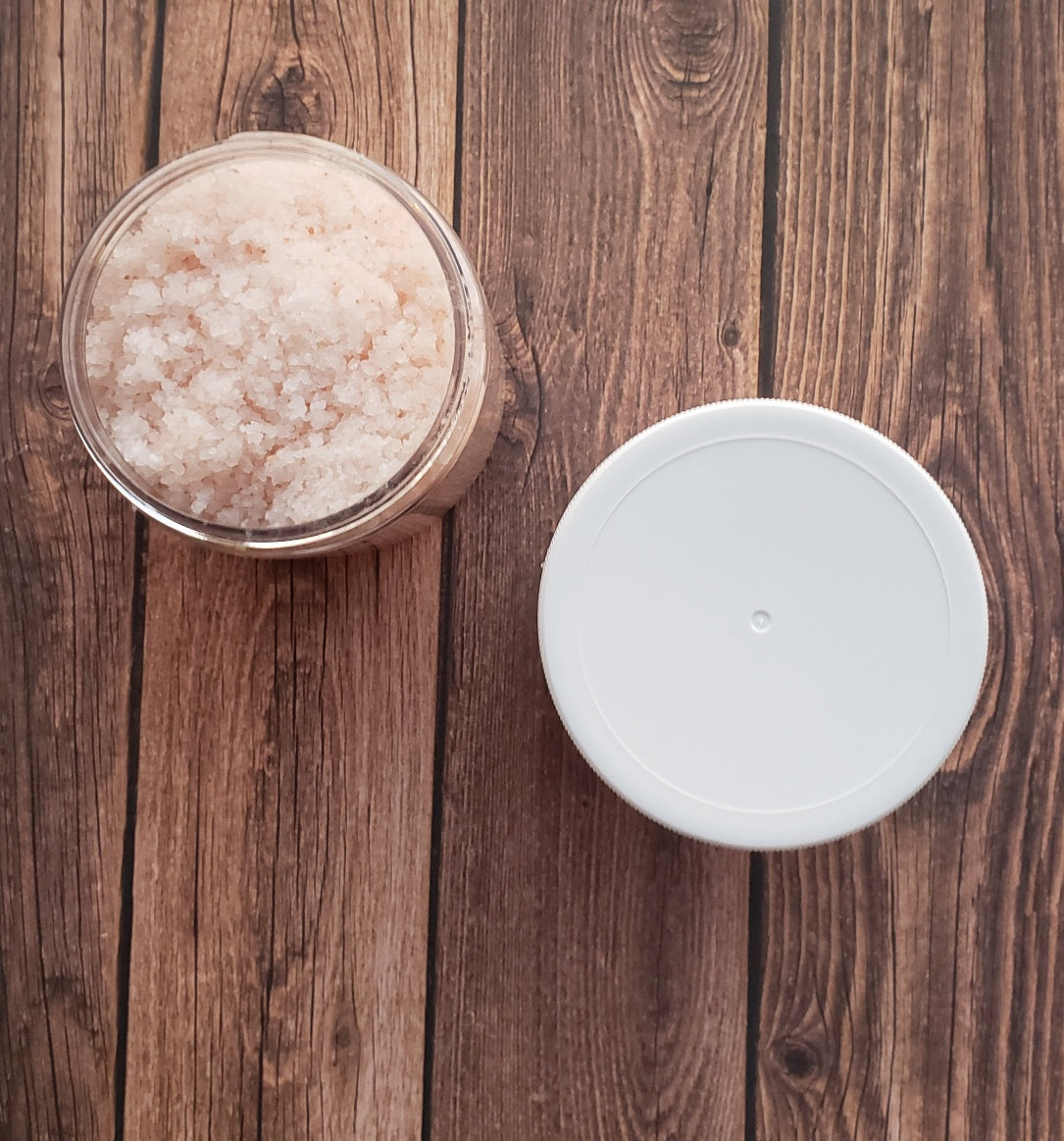 A jar of Eucalyptus Bath Salt with eucalyptus leaves and a wooden scoop, showcasing its natural ingredients and soothing properties.