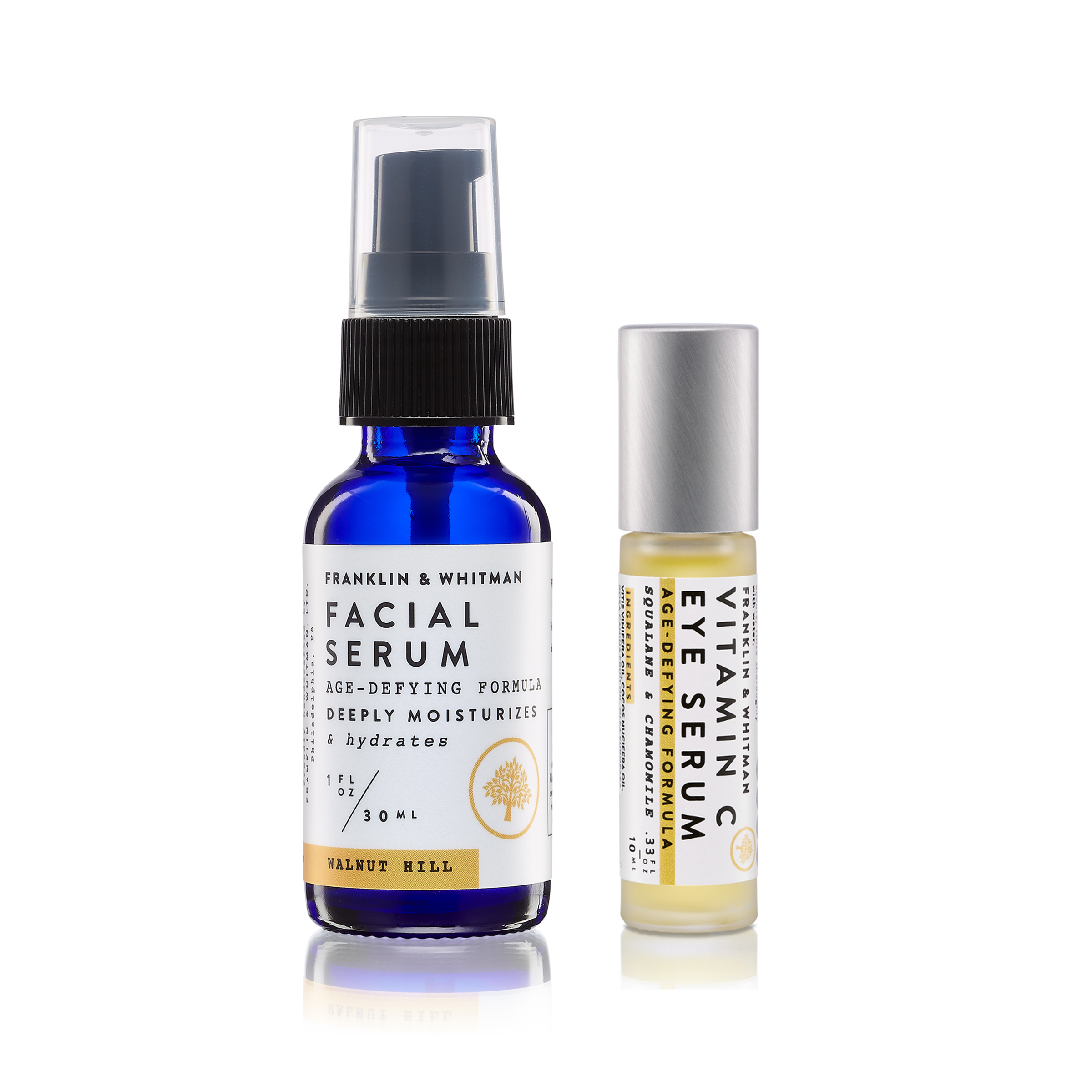 Eye & Facial Serum Kit featuring Walnut Hill Facial Serum and Vitamin C Eye Serum in glass bottles with a metal roller.