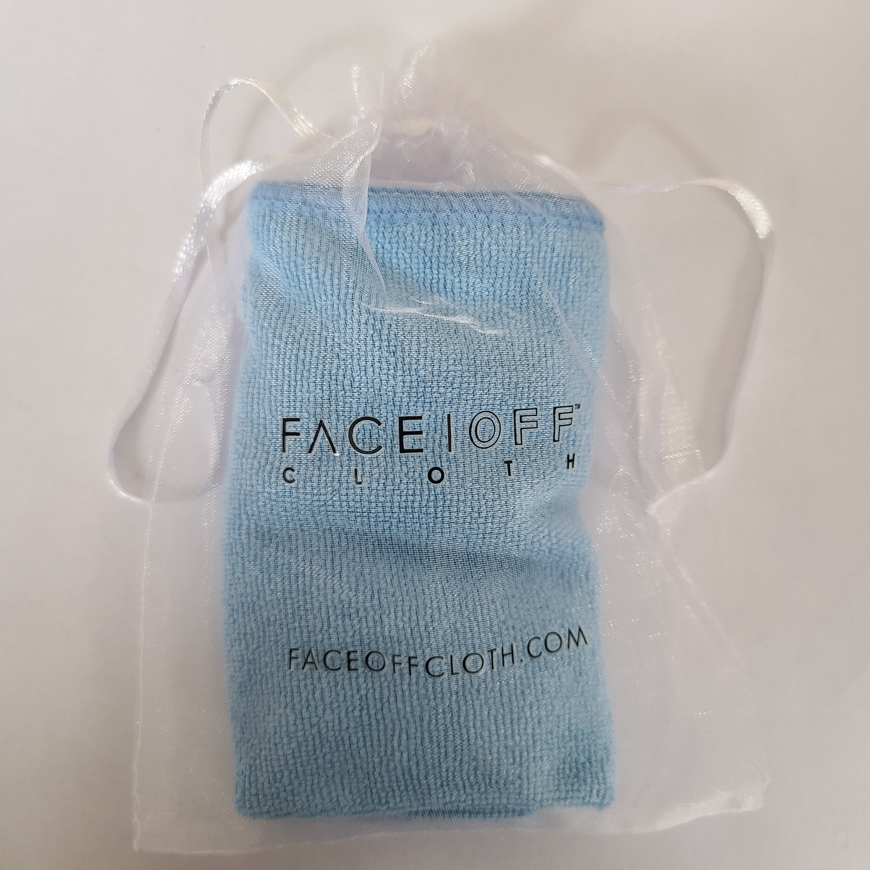 FaceOff Trial Cloth displayed on a clean surface, showcasing its soft texture and reusable design for makeup removal.