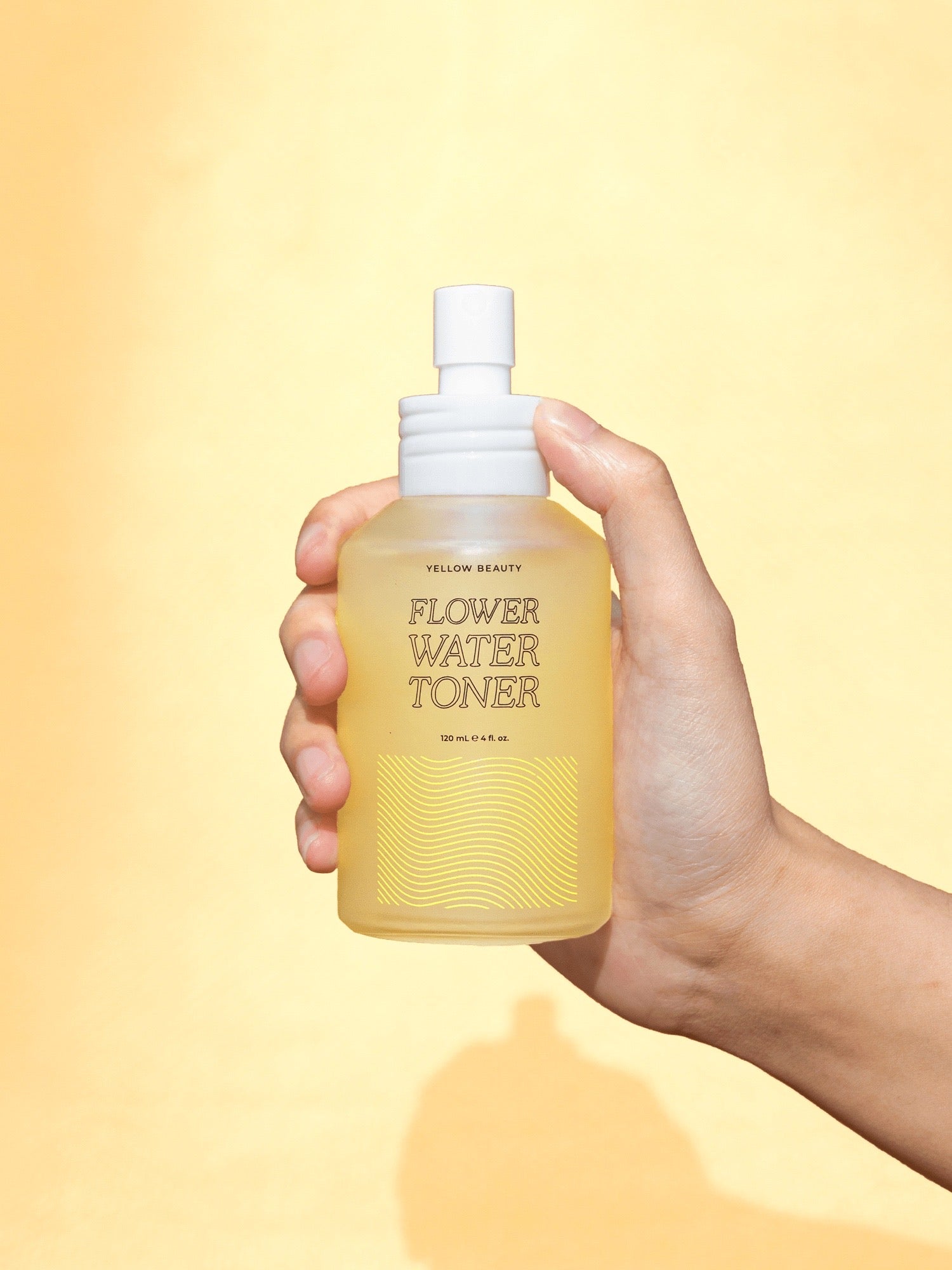 A bottle of Flower Water Toner with floral design, showcasing its hydrating and balancing properties for skin care.