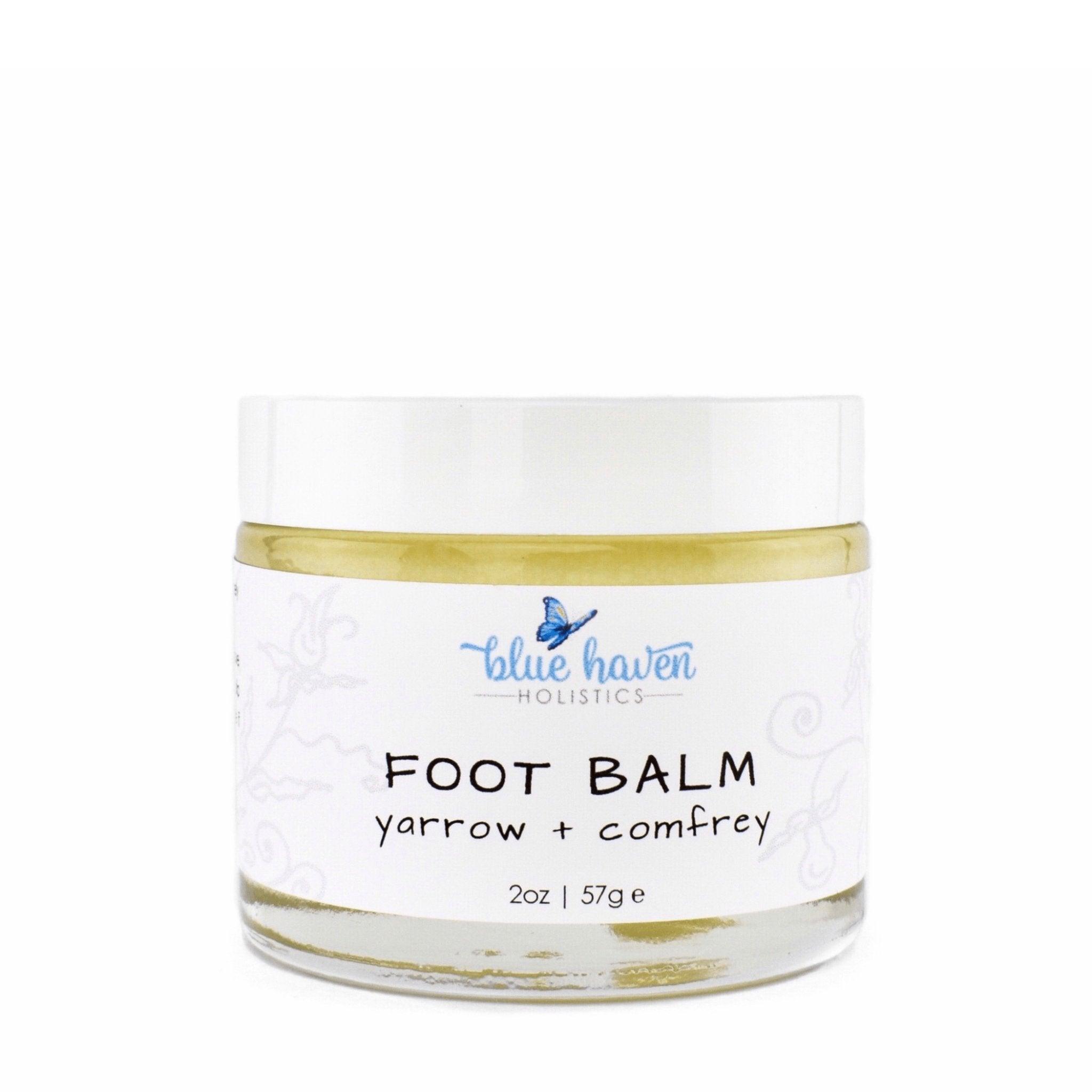 A jar of Yarrow + Comfrey Foot Balm, showcasing its creamy texture and natural ingredients, ideal for treating dry, cracked feet.