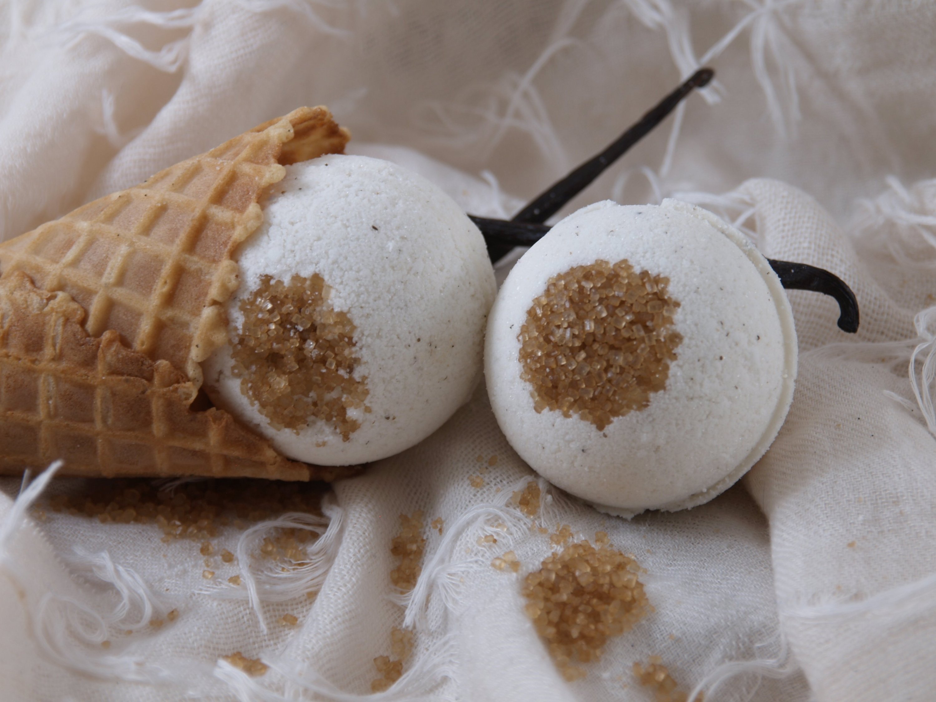 A vibrant French Vanilla Bath Bomb with a walnut topping, showcasing its effervescent and aromatic qualities, perfect for a relaxing bath experience.