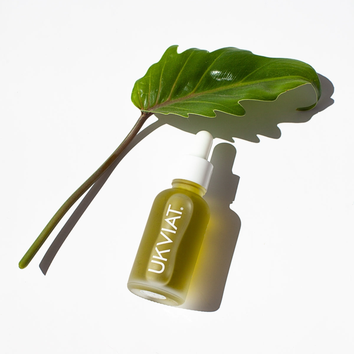 Green protective facial serum in a sleek bottle, showcasing its natural ingredients and eco-friendly packaging.