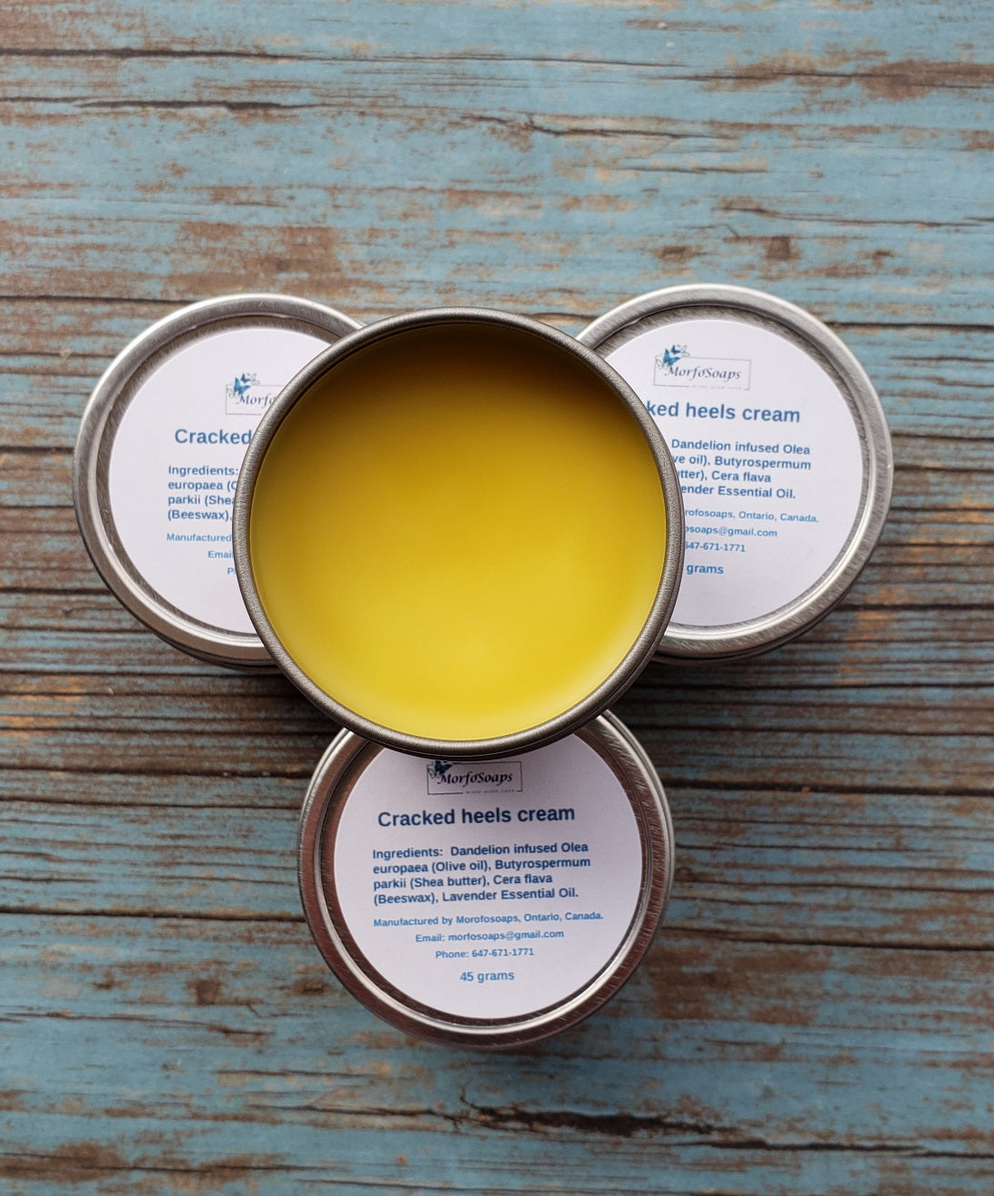 A jar of Handmade Cracked Heels Cream featuring natural ingredients like Dandelion, Shea butter, and beeswax, designed for foot care.