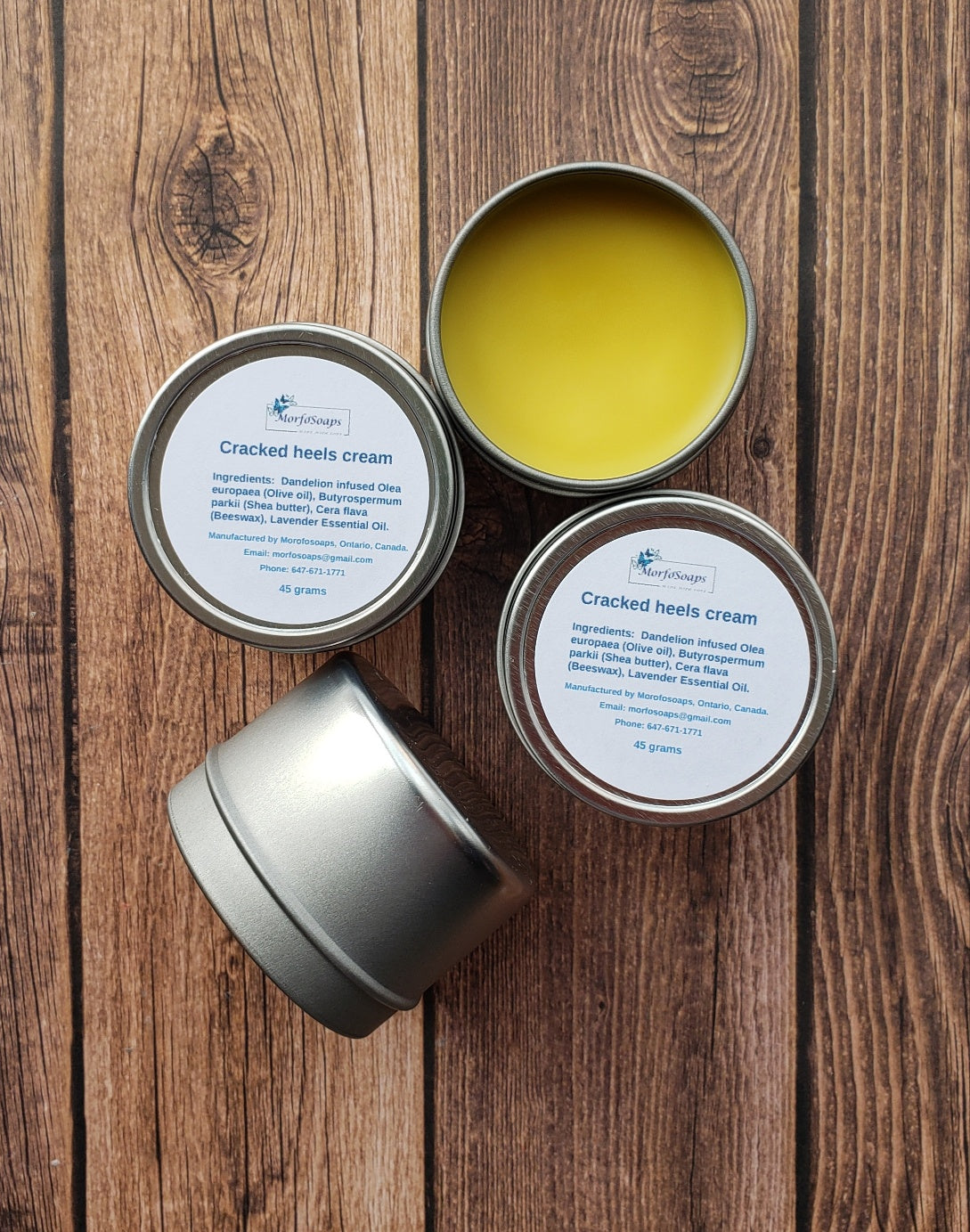 A jar of Handmade Cracked Heels Cream featuring natural ingredients like Dandelion, Shea butter, and beeswax, designed for foot care.