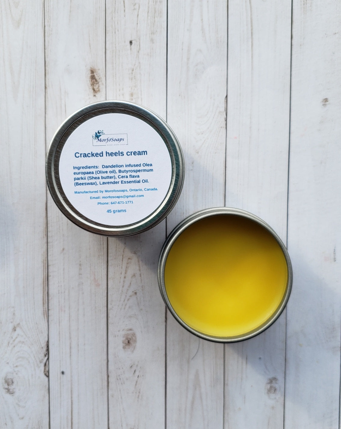 A jar of Handmade Cracked Heels Cream featuring natural ingredients like Dandelion, Shea butter, and beeswax, designed for foot care.