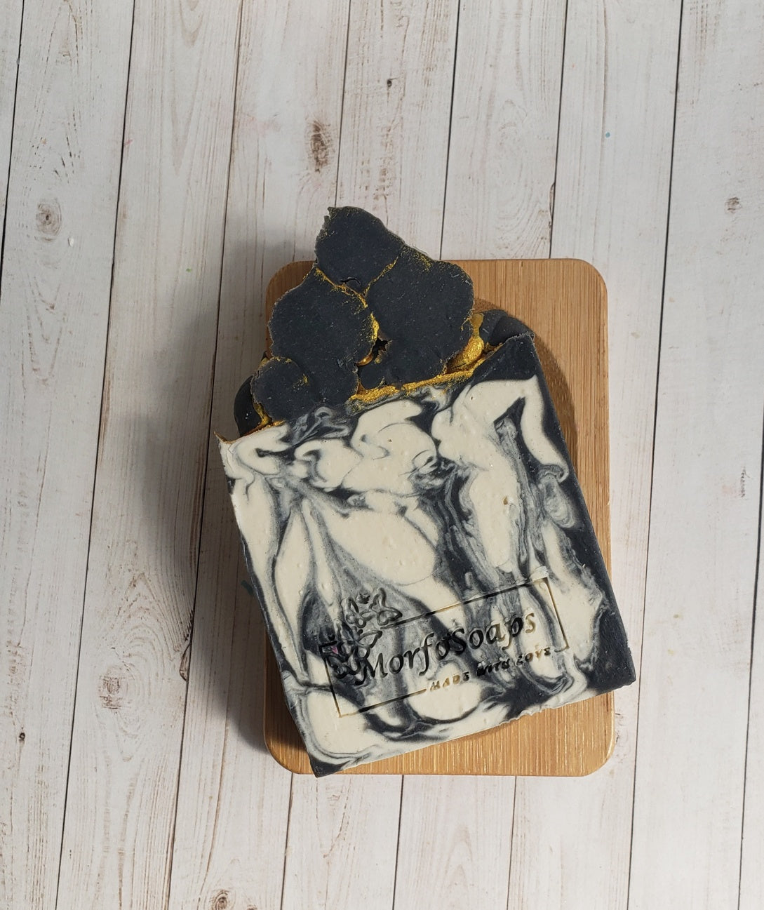 A bar of Handmade Sandalwood Soap showcasing its unique design and rich texture, with a warm sandalwood scent.