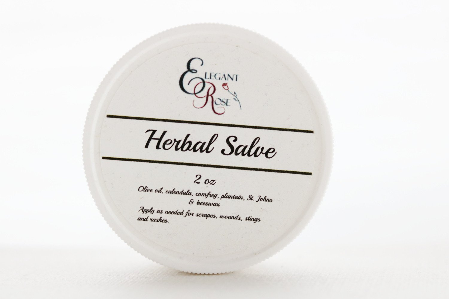 A 2 oz jar of Herbal Salve, an all-purpose skin salve made with organic herbs infused in olive oil, ideal for rashes and burns.