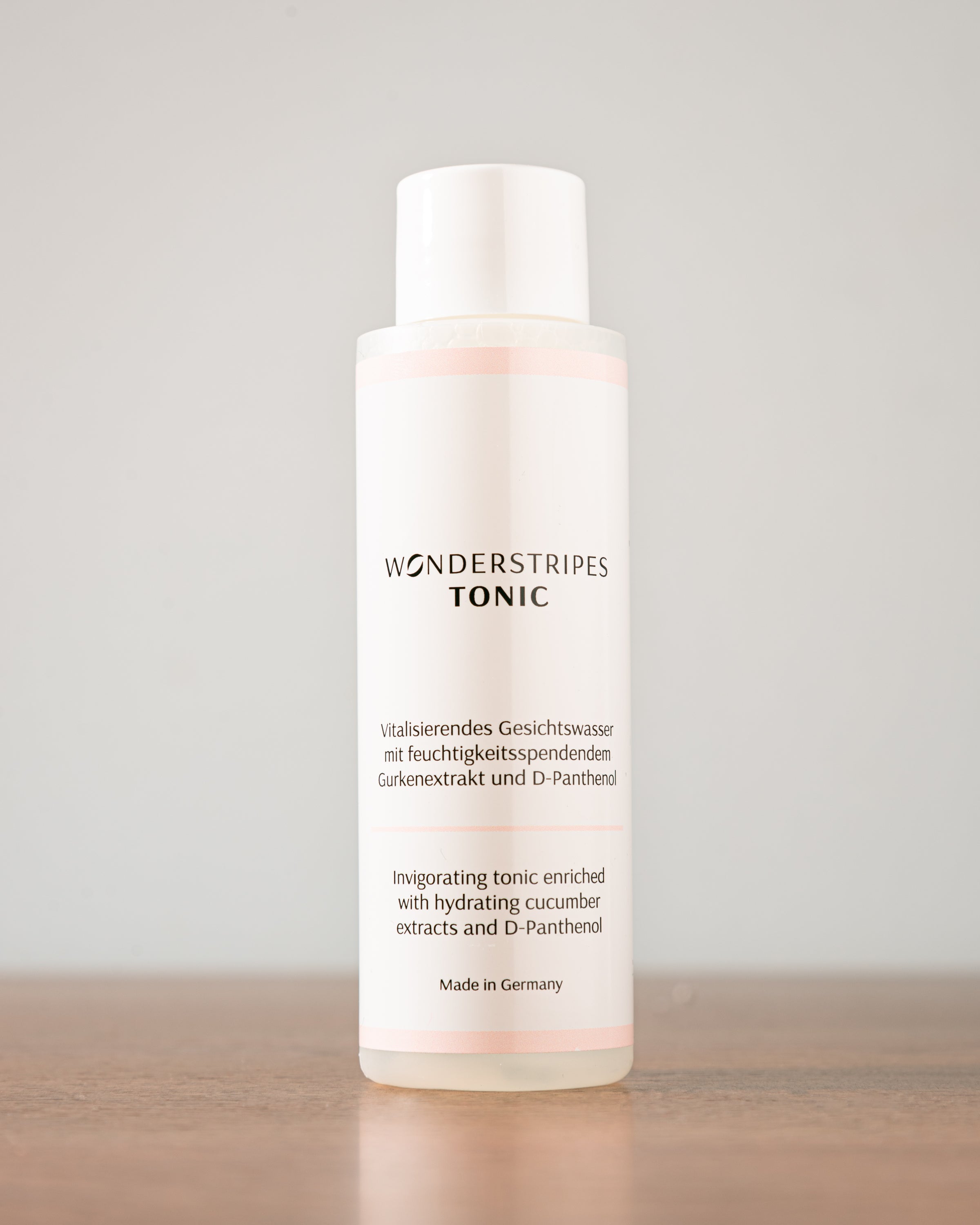 A 100ml bottle of Hydrating Toner featuring a sleek design, showcasing its key ingredients like cucumber extract and D-Panthenol.