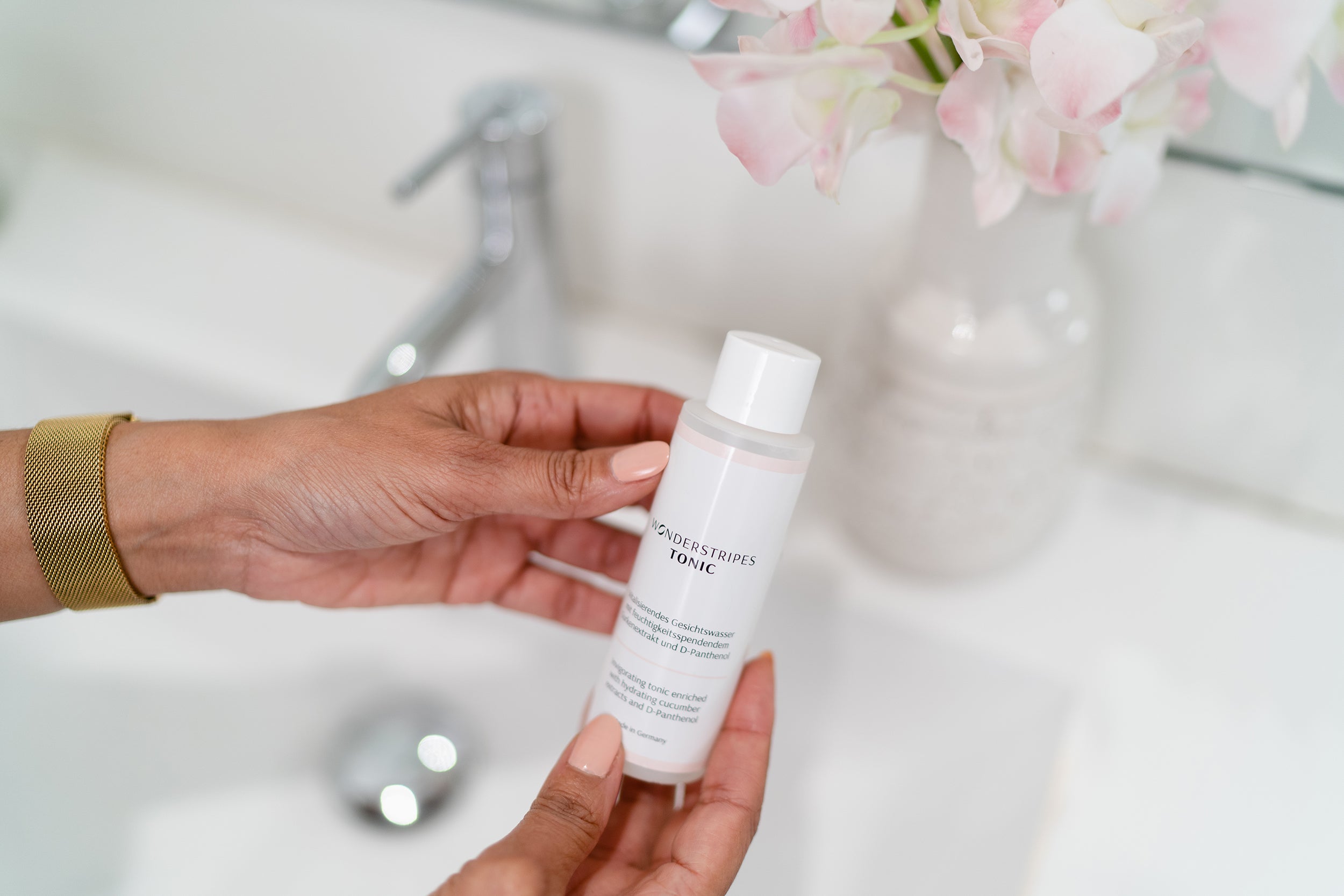 A 100ml bottle of Hydrating Toner featuring a sleek design, showcasing its key ingredients like cucumber extract and D-Panthenol.