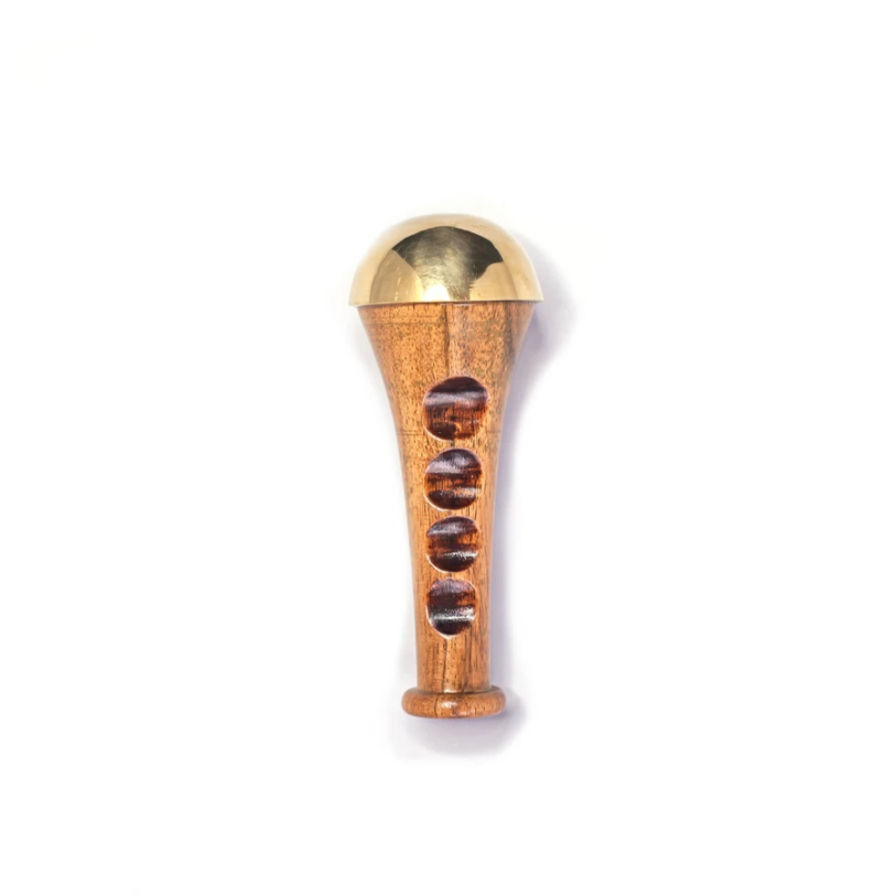 Kansa Wand Facial Tool made from teak wood and Kansa metal, showcasing its ergonomic design and ancient Ayurvedic heritage.