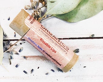 Kissable Lips Chapstick Lip Balm in a sleek tube, showcasing its organic ingredients and glossy finish, perfect for achieving soft, hydrated lips.