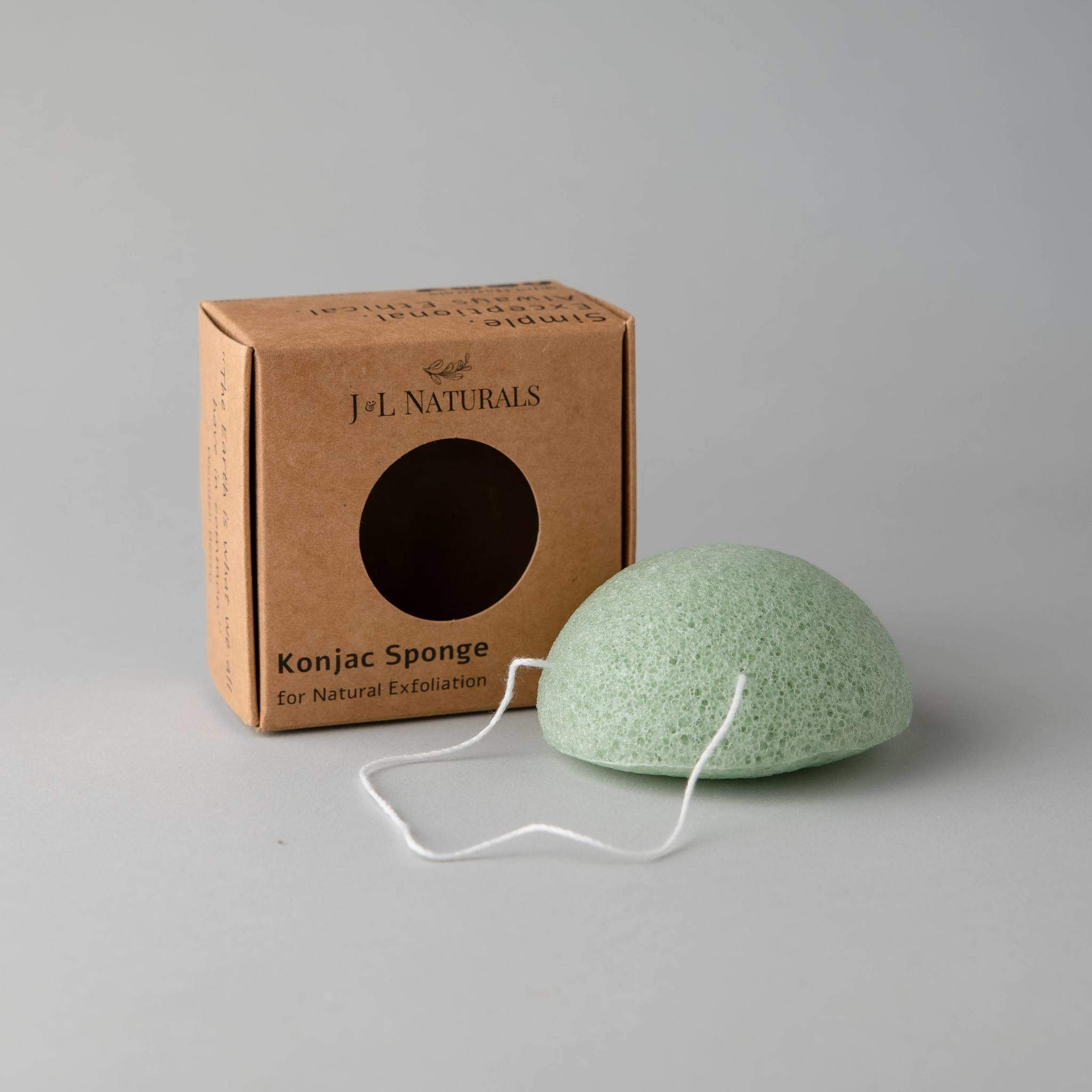 A collection of five biodegradable Konjac sponges in various colors, each representing different skin benefits, displayed on a natural wooden surface.