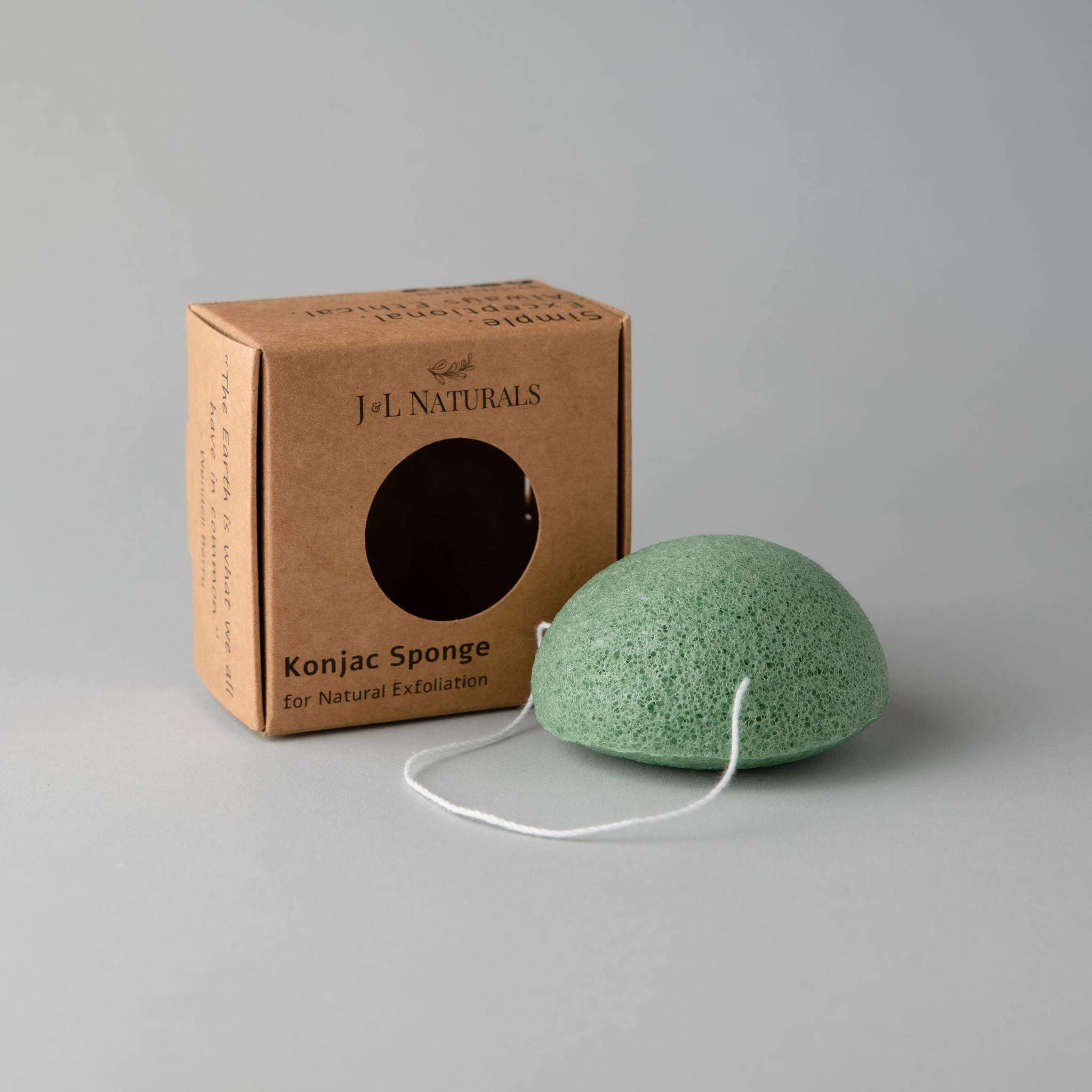 A collection of five biodegradable Konjac sponges in various colors, each representing different skin benefits, displayed on a natural wooden surface.